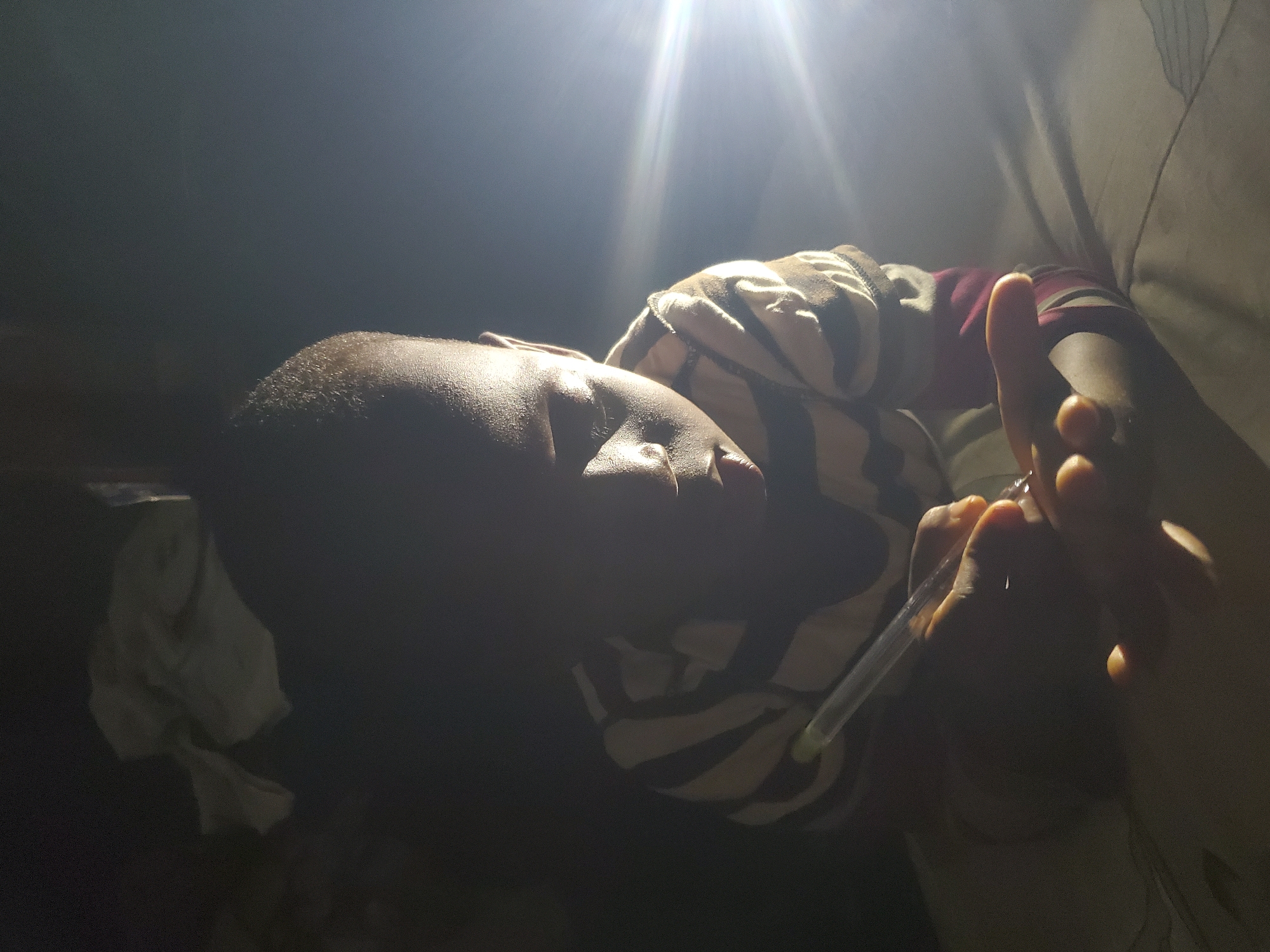 Evening indoor gathering documented by witness, thermometer present