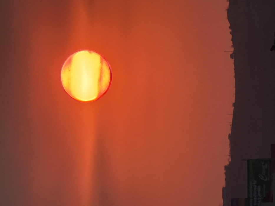 Sunset captured over Mexican town with volcanic mountain backdrop