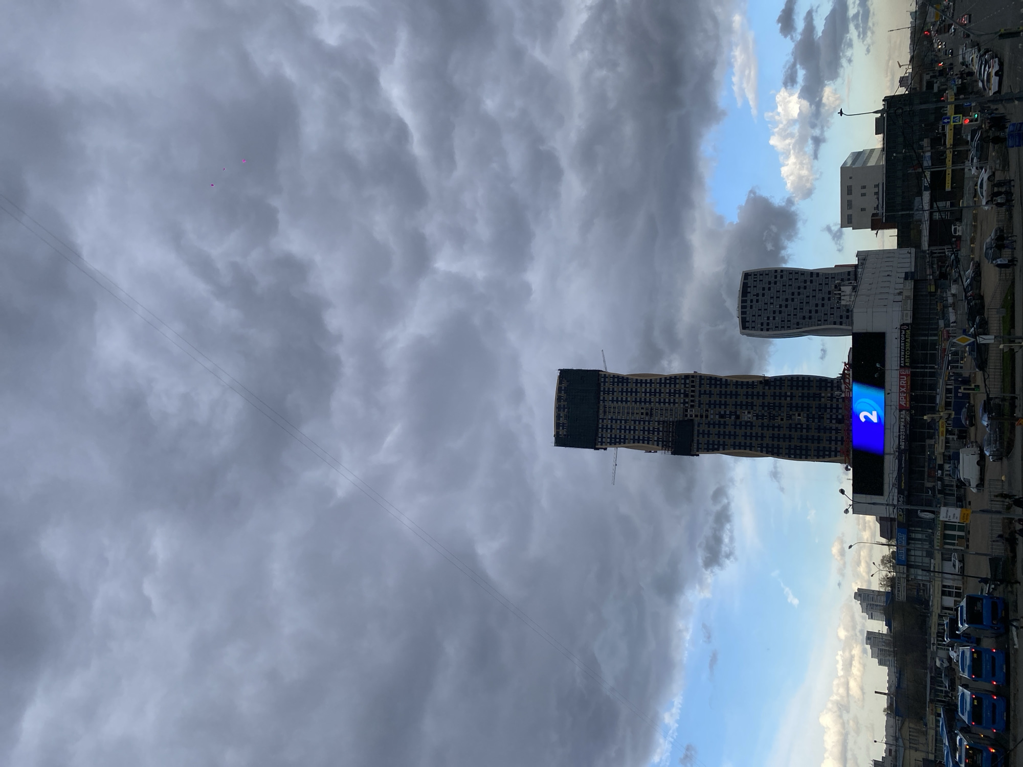 Moscow afternoon: stormy skies over construction, bakers at work