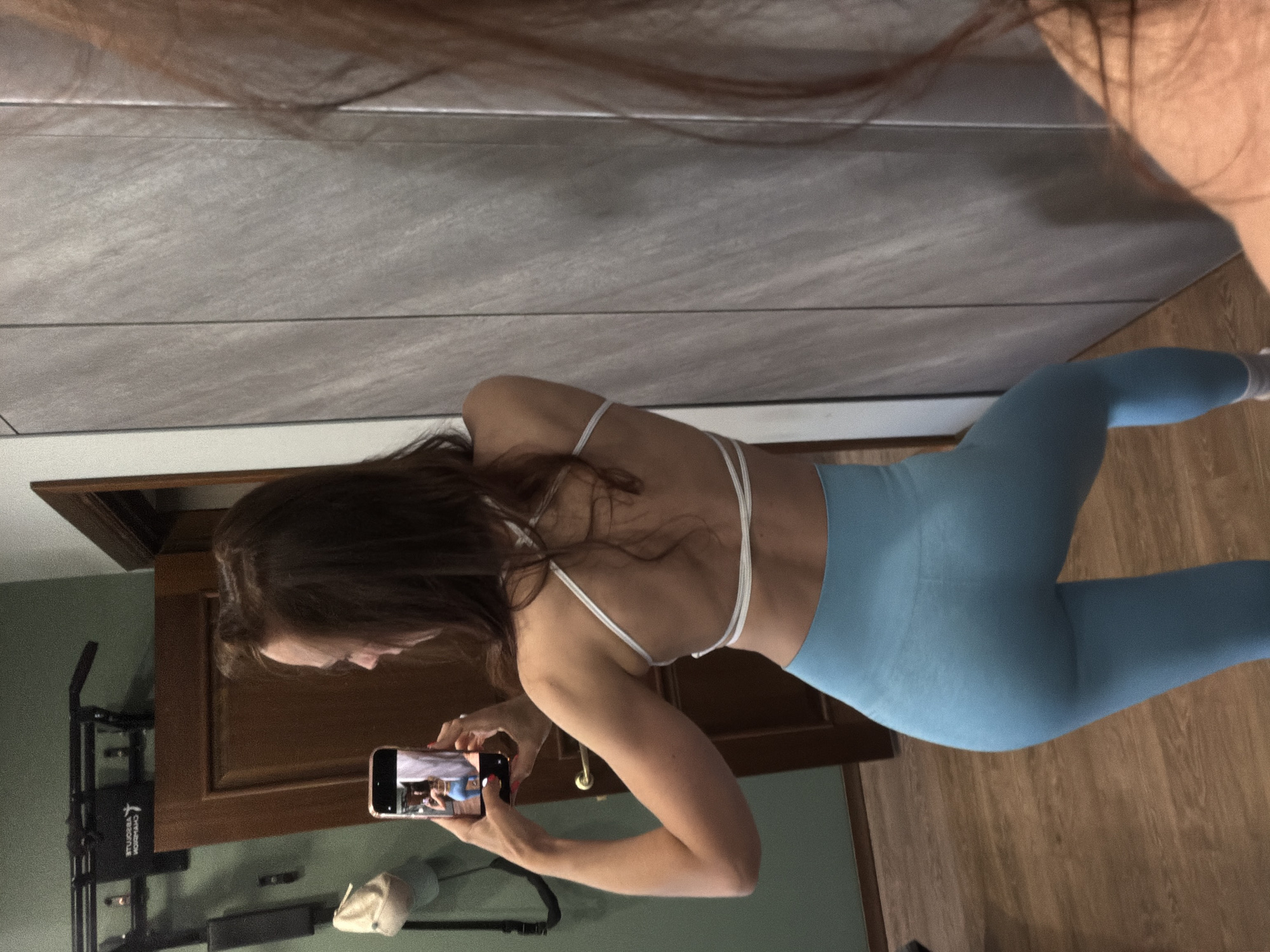 Woman takes mirror selfies in athletic wear in Birobidzhan