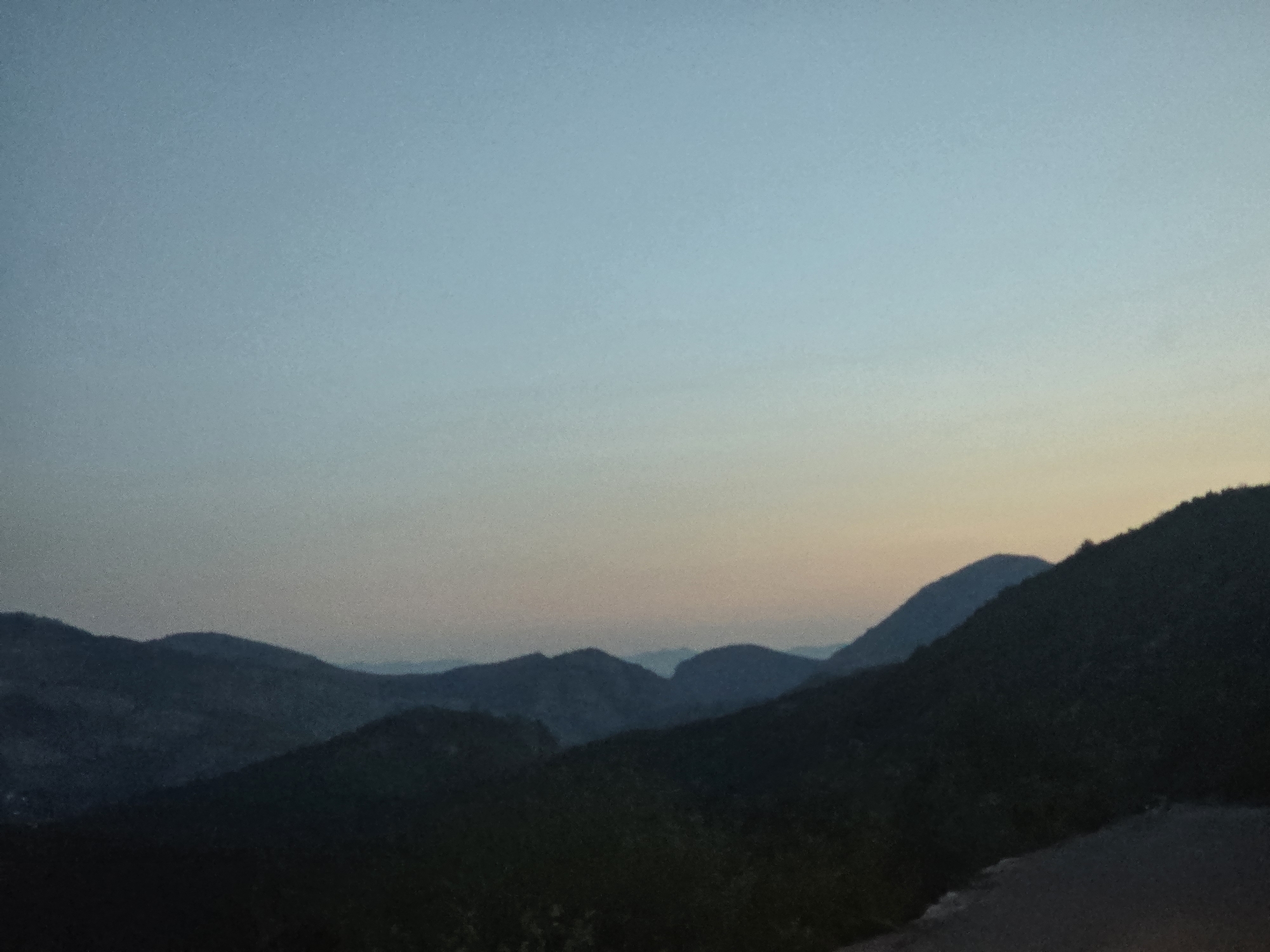 Dusk stop on a Montenegrin mountain road, memorial and all