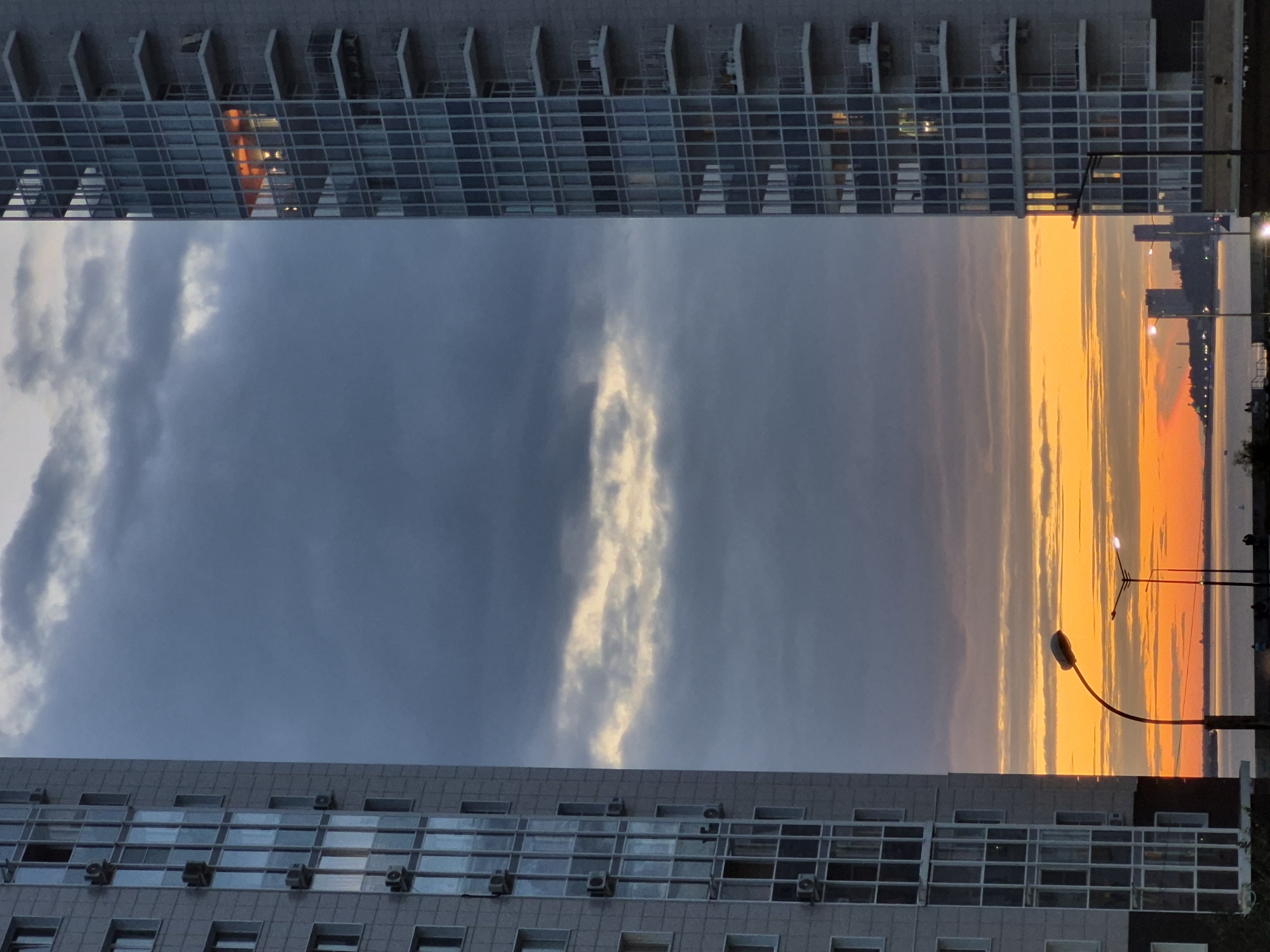 Rainbow and sunset light over Khabarovsk apartment blocks