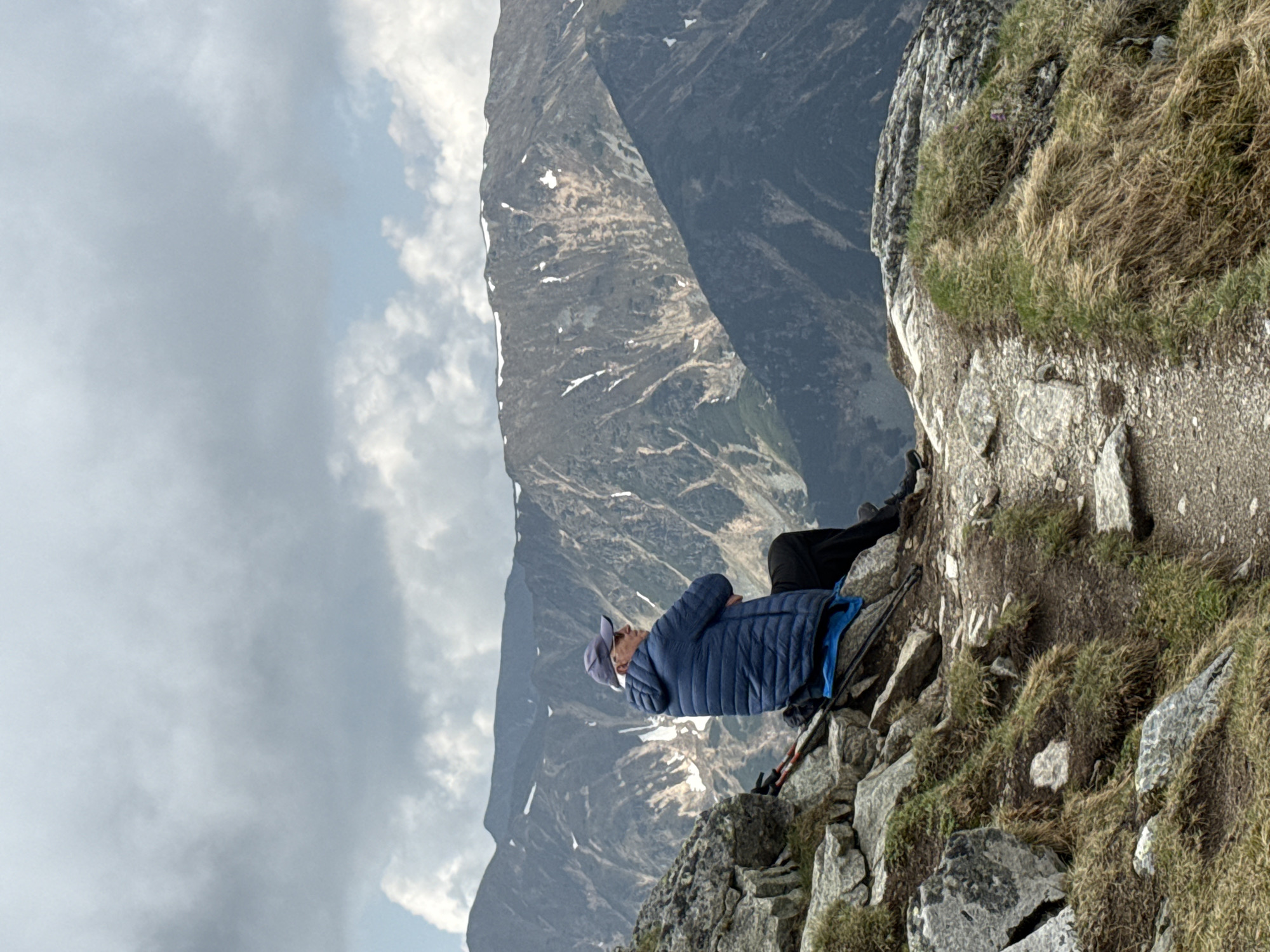 Hiker rests on cloudy Tatra Mountain trail near Zakopane