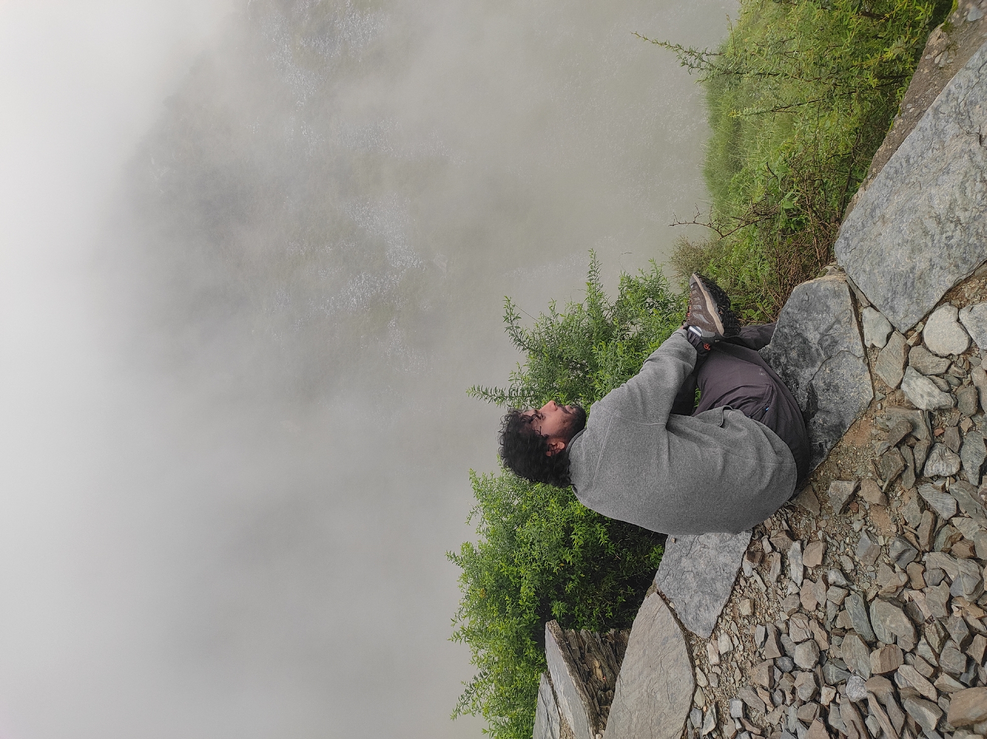 Sitting on a rocky ledge, gazing into fog