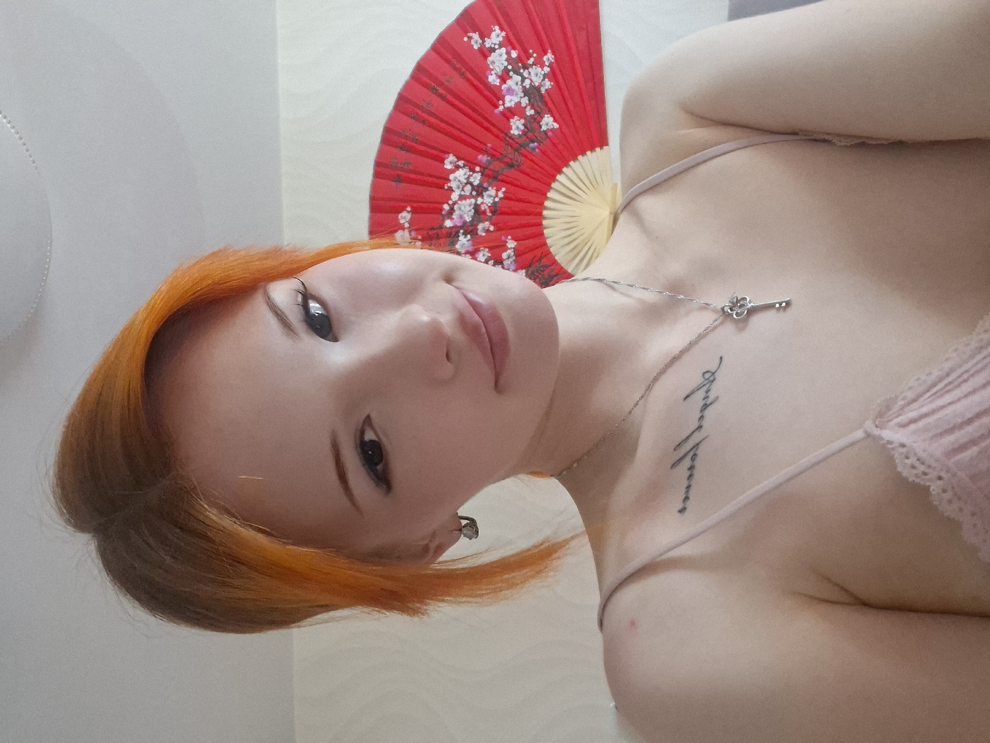 Woman poses with decorative fan in Chaikovsky indoor photo session