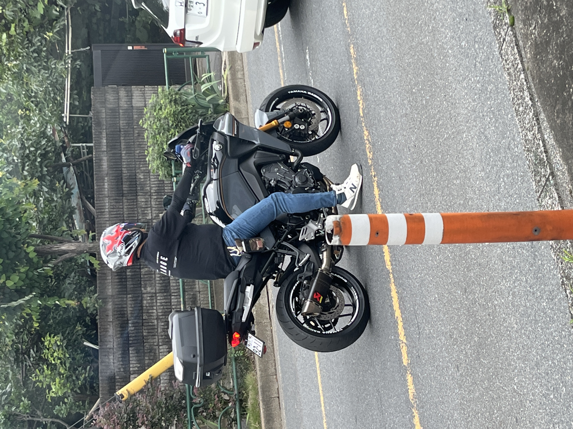Sport-touring motorcycle with cargo box rolling through Nerima streets