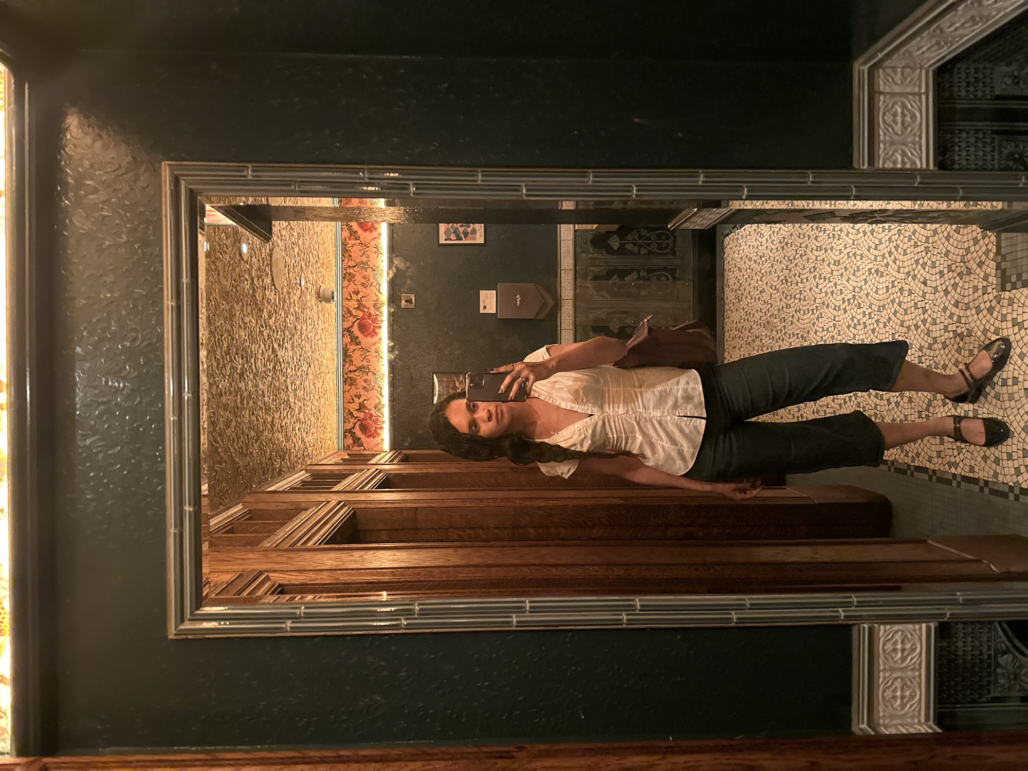 Woman Takes Mirror Selfie in London Enclosed Space