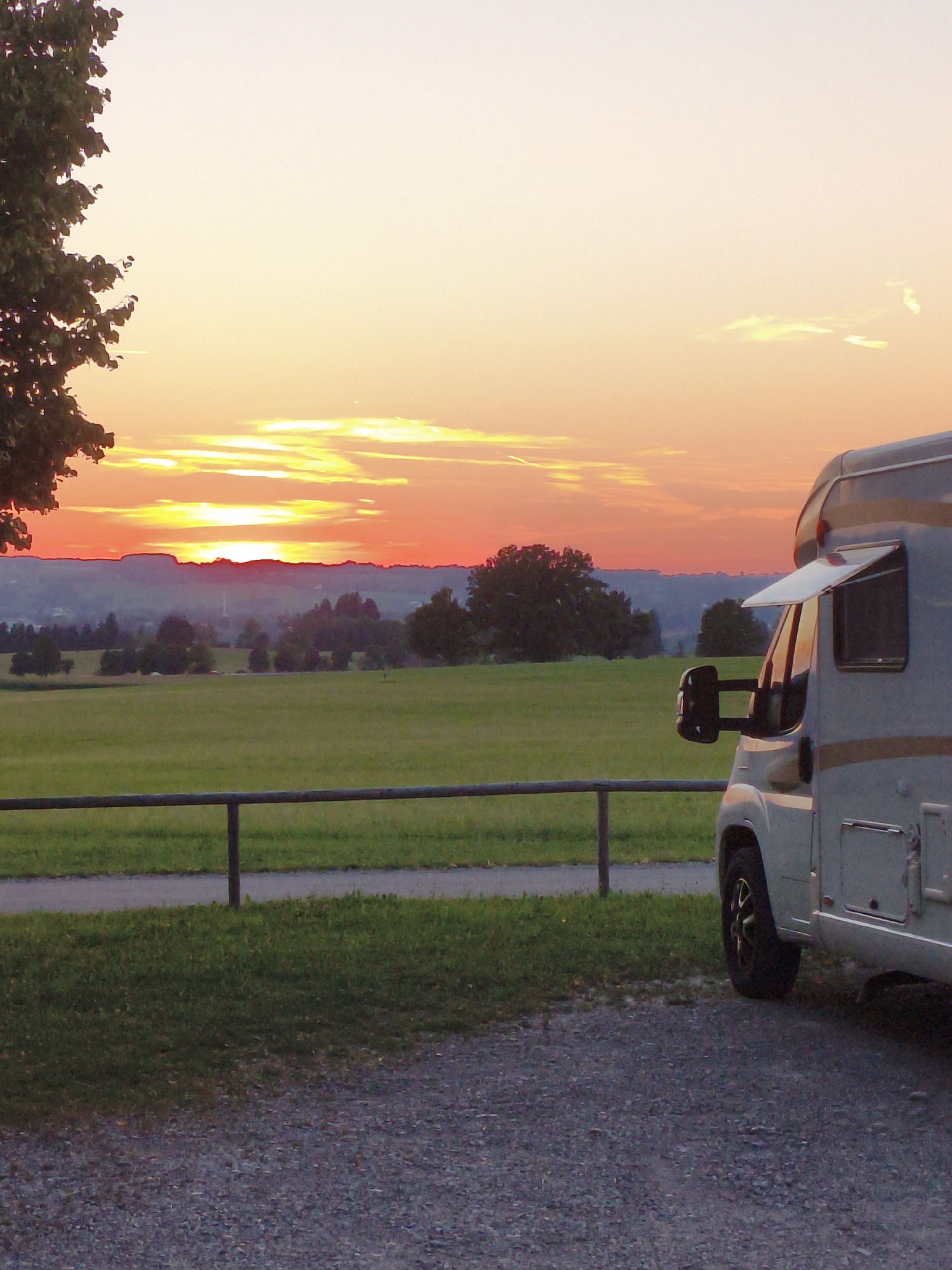 Campsite evening in rural Mauerstetten with grazing cattle and sunset