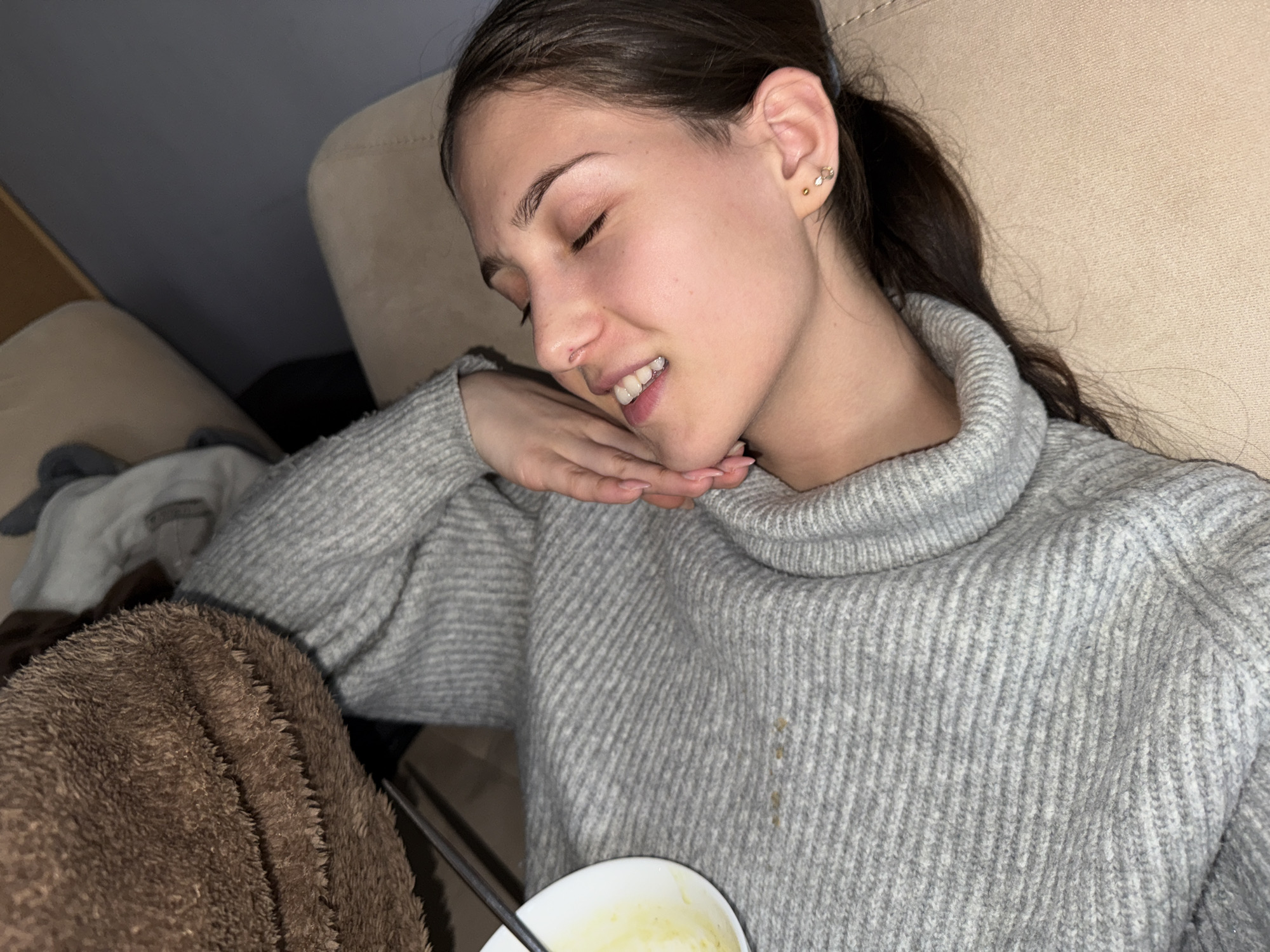 Woman rests on couch in Sofia apartment