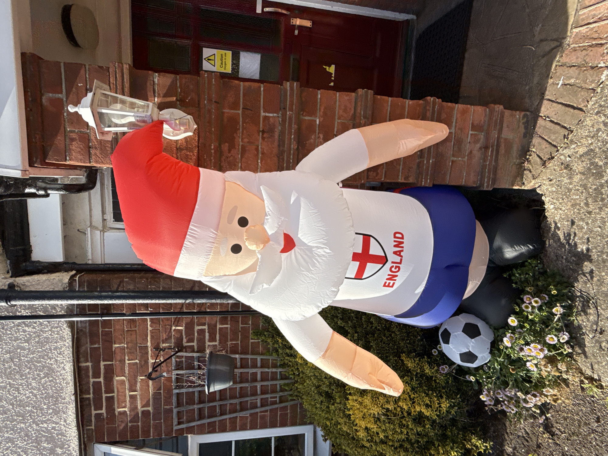Inflatable Santa suits up in England kit outside Great Yarmouth home