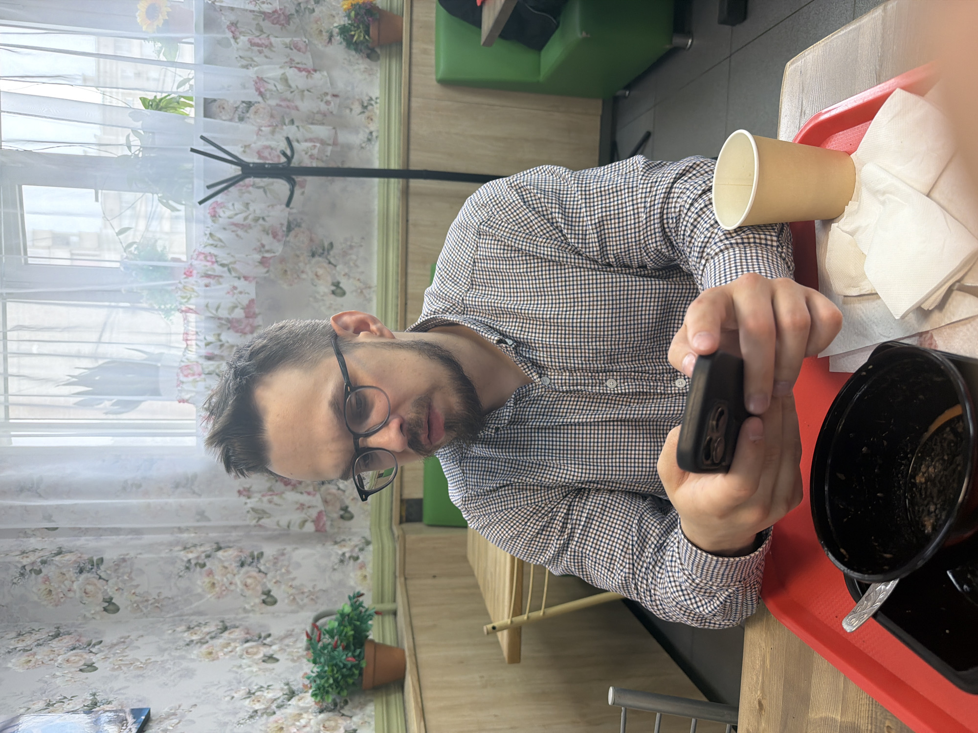 Man uses phone during breakfast in Krasnoyarsk