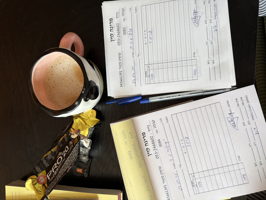 Woman works with documents on couch in Tel Aviv apartment