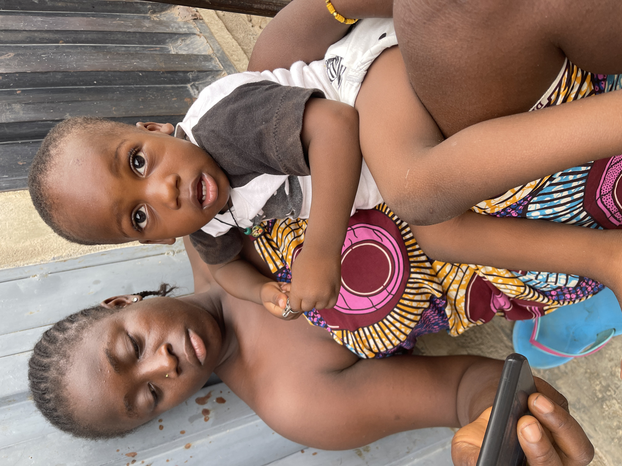 Child photographed on concrete pavement in Nyanya, Nigeria