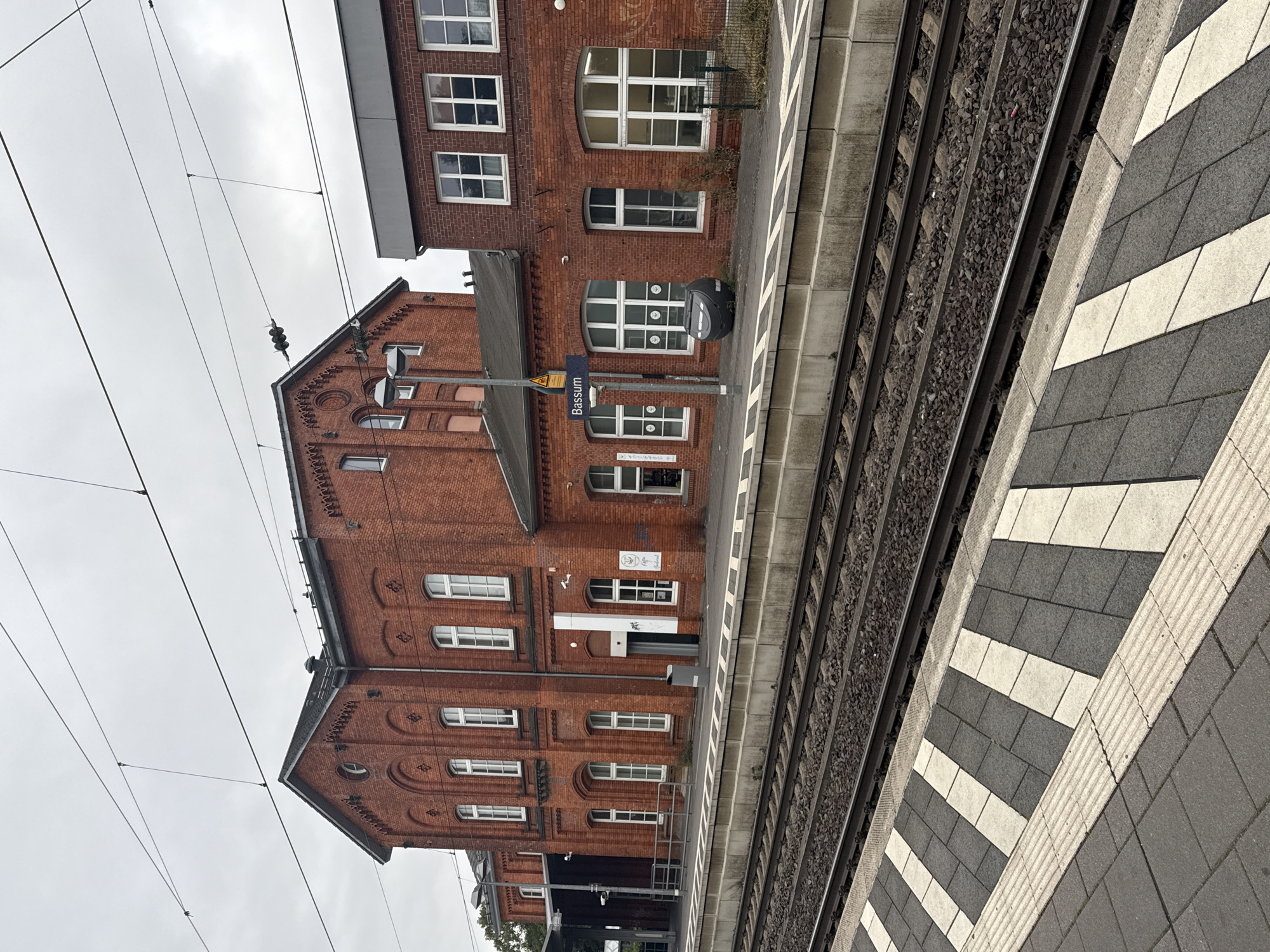 Freight train rolls through Bassum station on a quiet morning