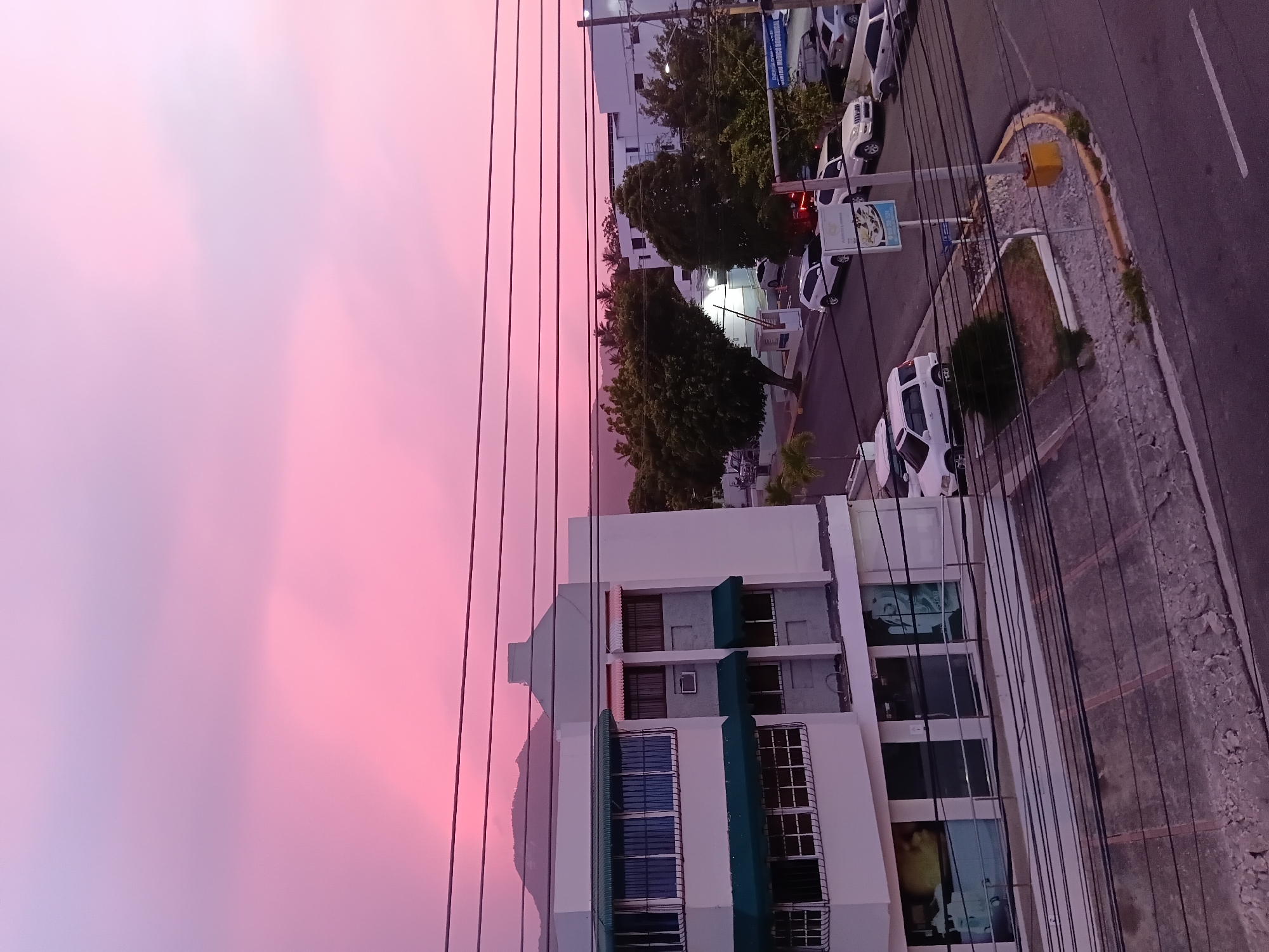 Pink sunset sky over Puerto Plata streets at dusk