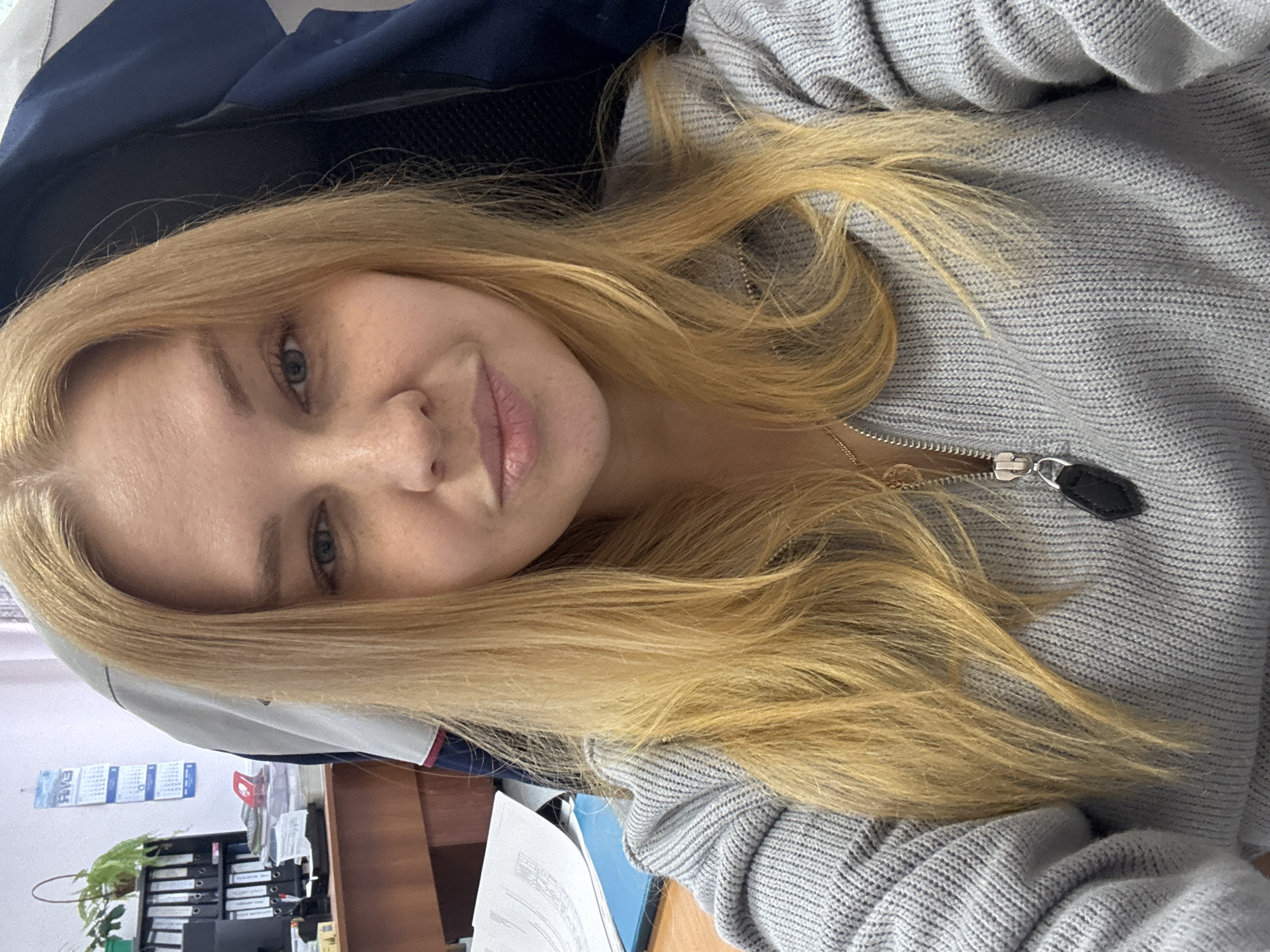 Woman photographed twice in office setting in Rusanovo, Russia
