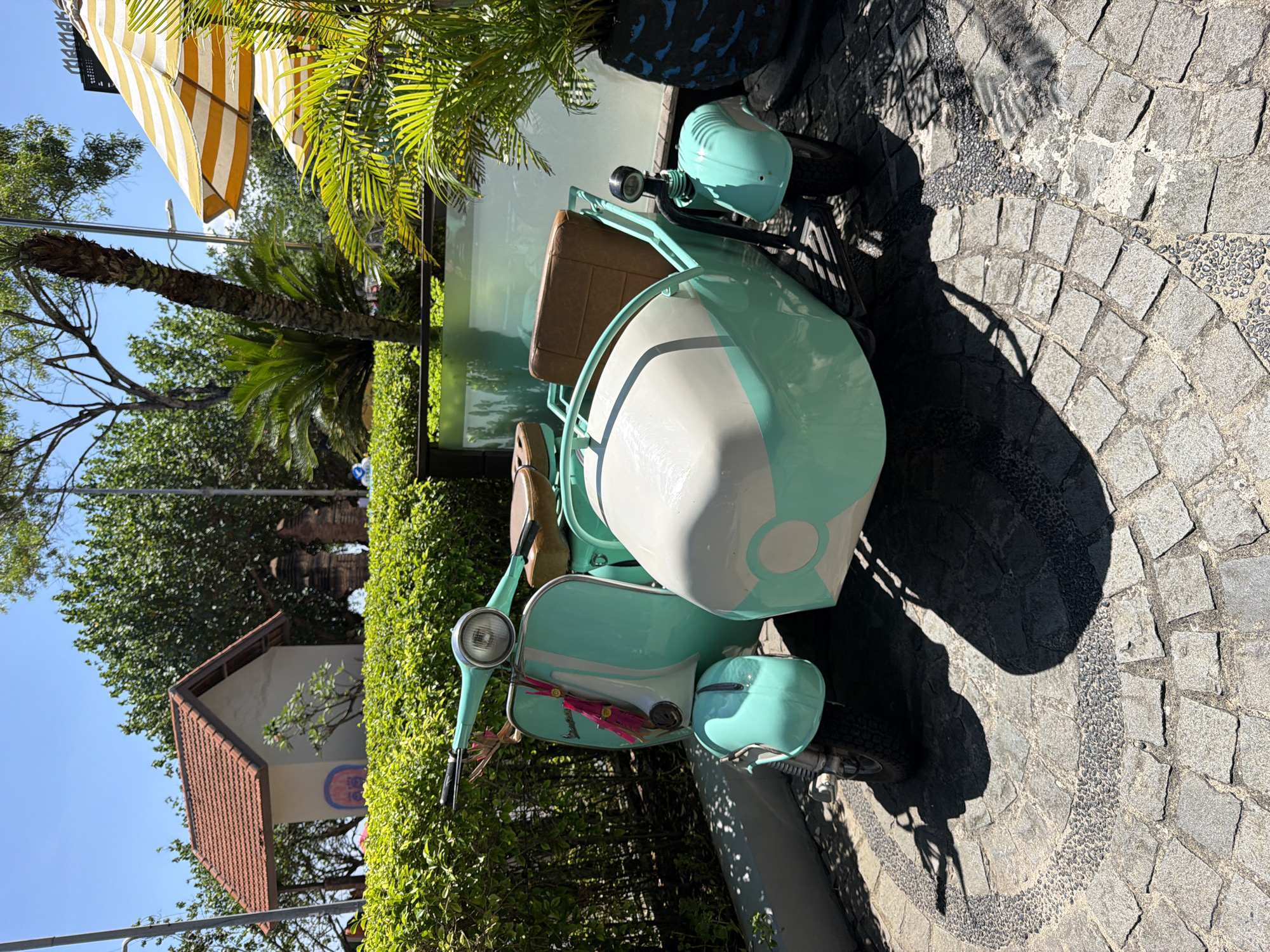 Vintage Vespa and local meal captured in Kuta