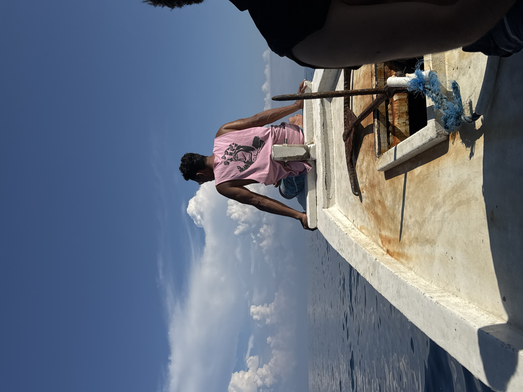 Man sits on boat edge in Indonesia