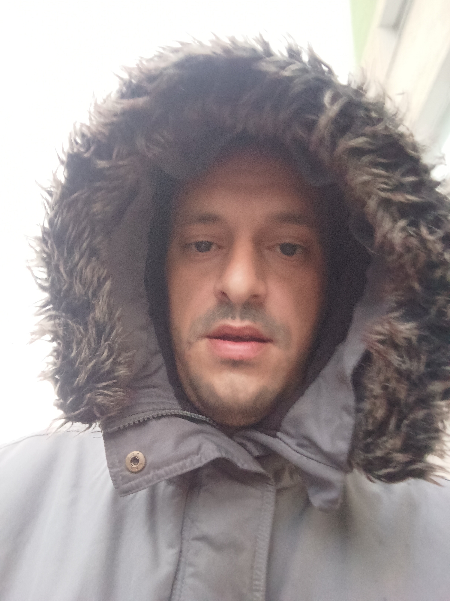 Man in hooded winter coat photographed in Burgas