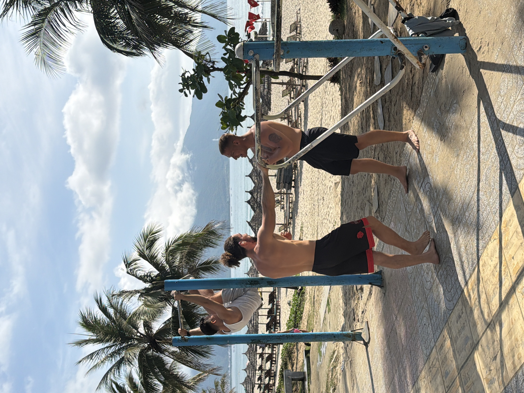 Men exercise on parallel bars in Đà Nẵng Vietnam