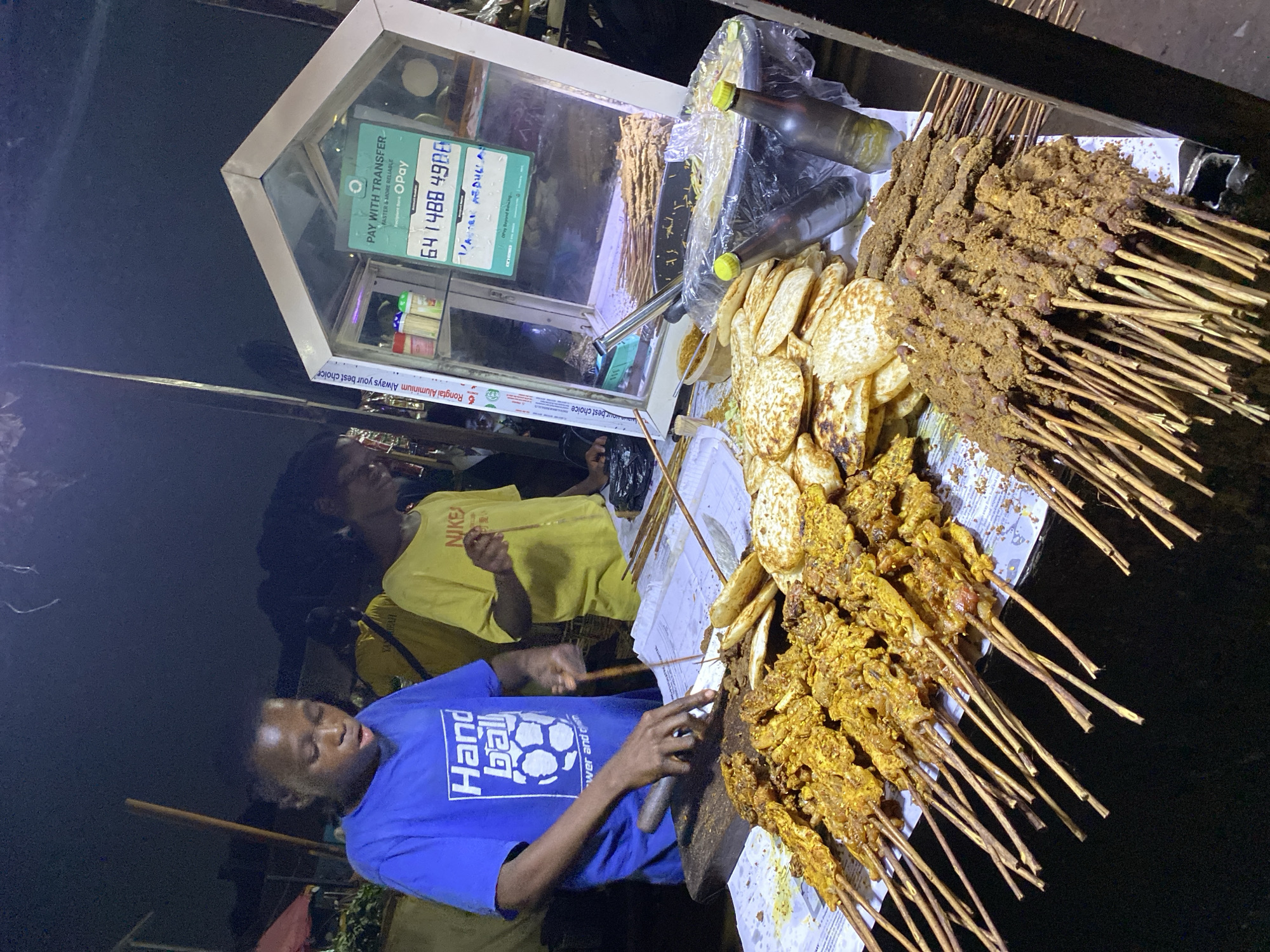 Evening street food and shop activity documented in Rido