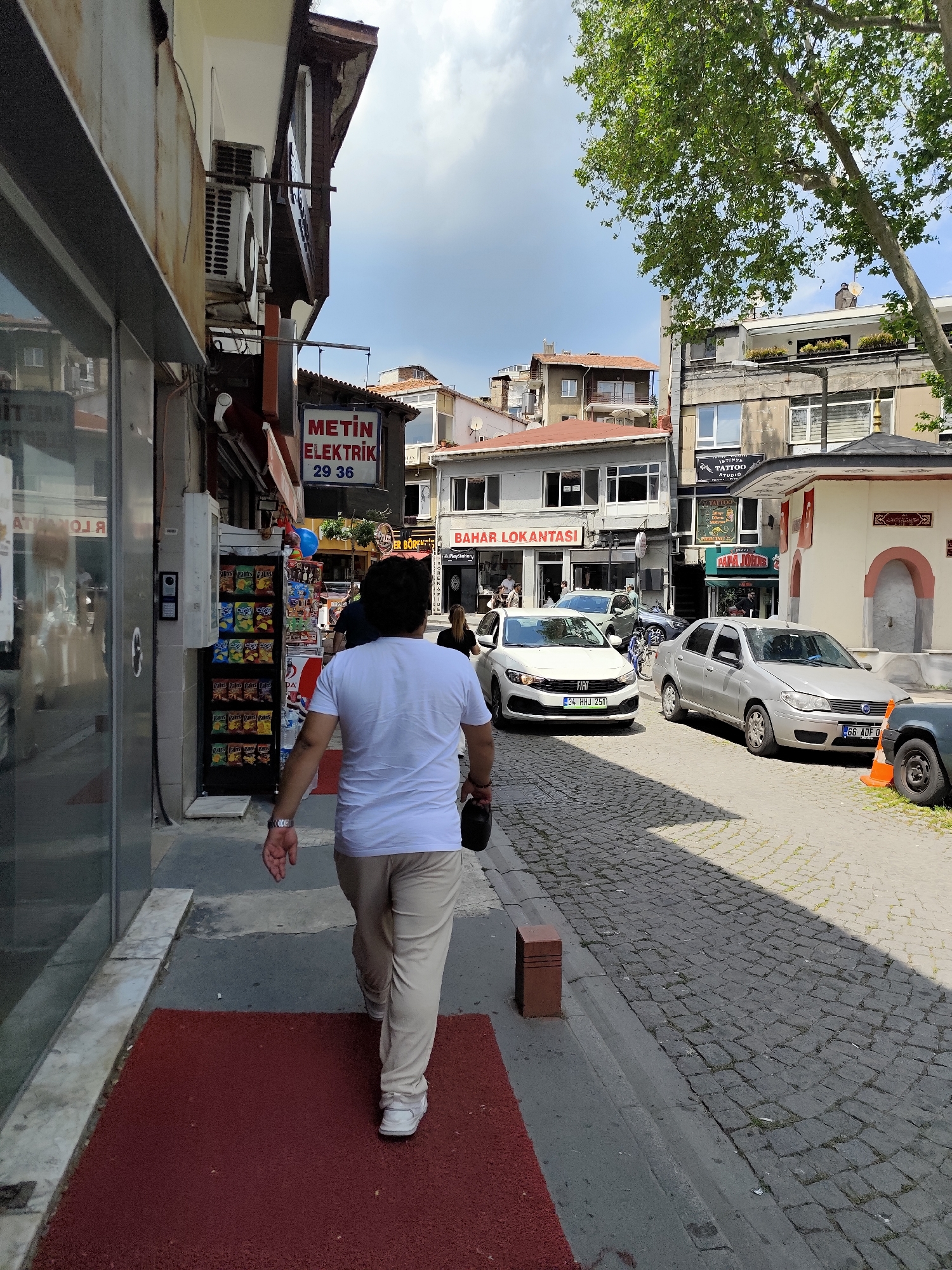 Person walks cobblestone street in Sarıyer Turkey morning