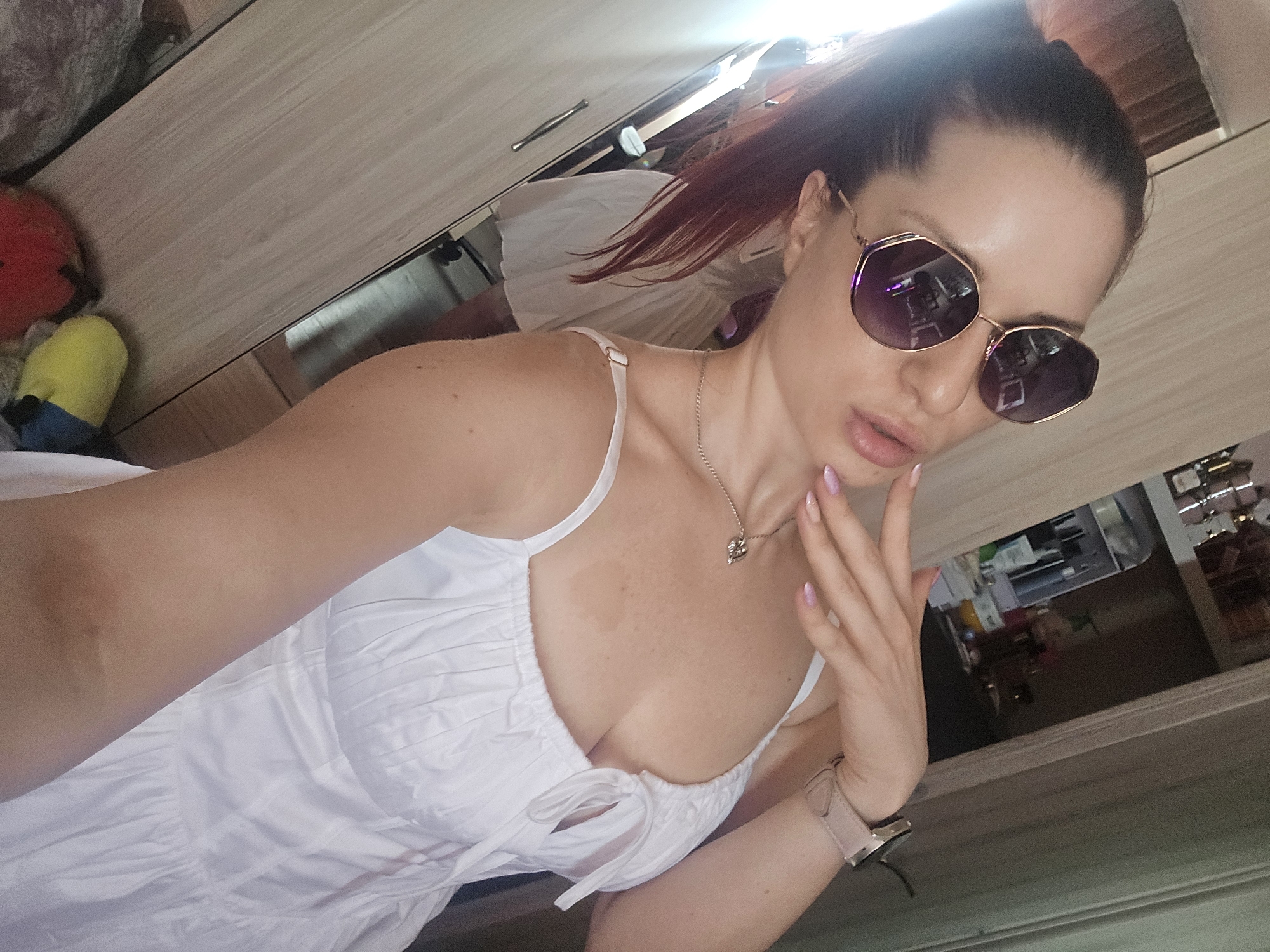Selfie session in a Burgas room, purple shades and white dress