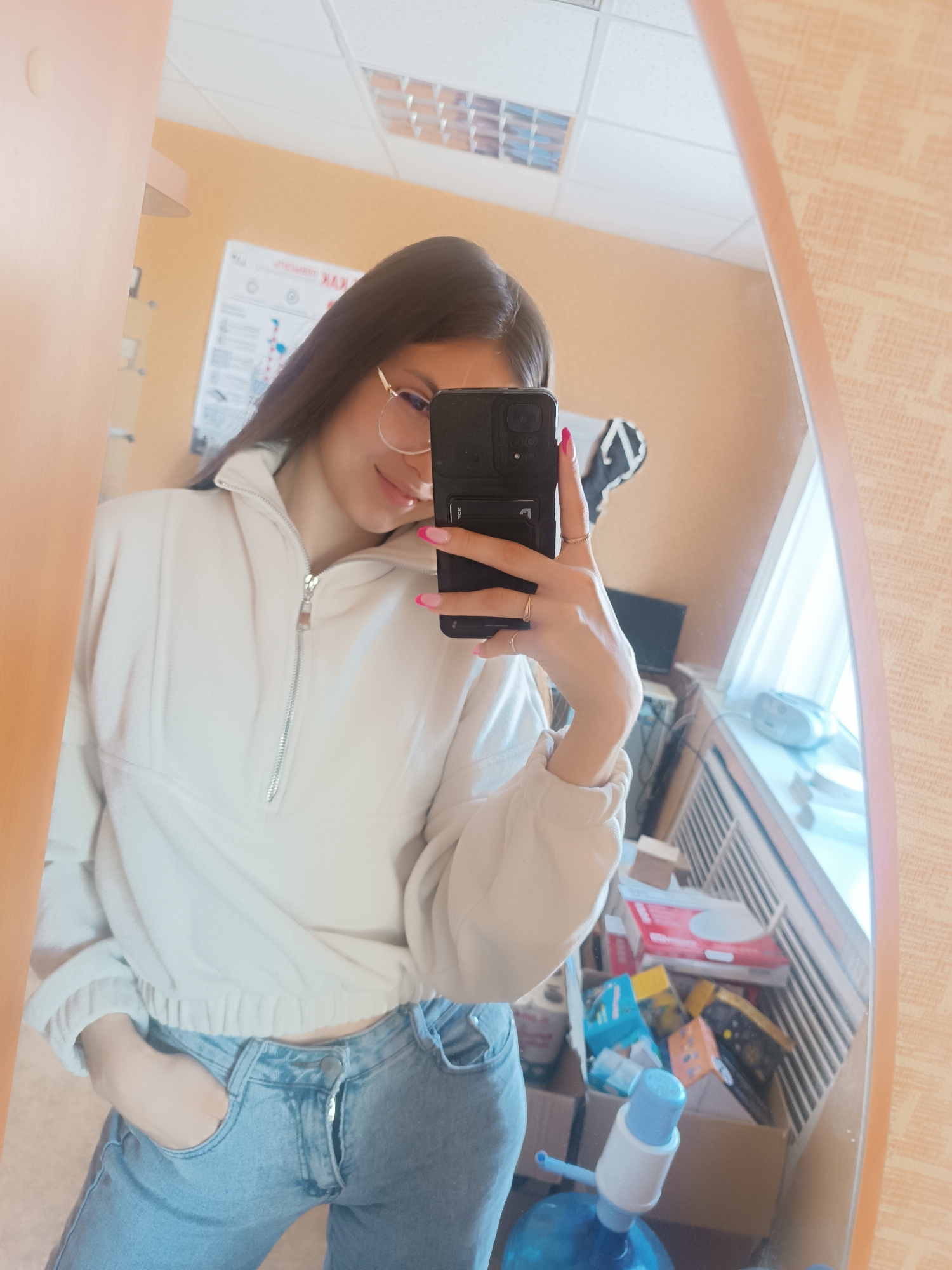 Woman Takes Mirror Selfies in Light Sweatshirt and Jeans