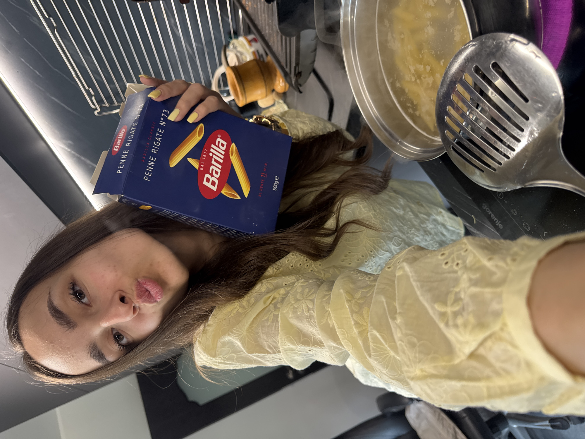 Woman cooks pasta, takes selfie in Sofia home