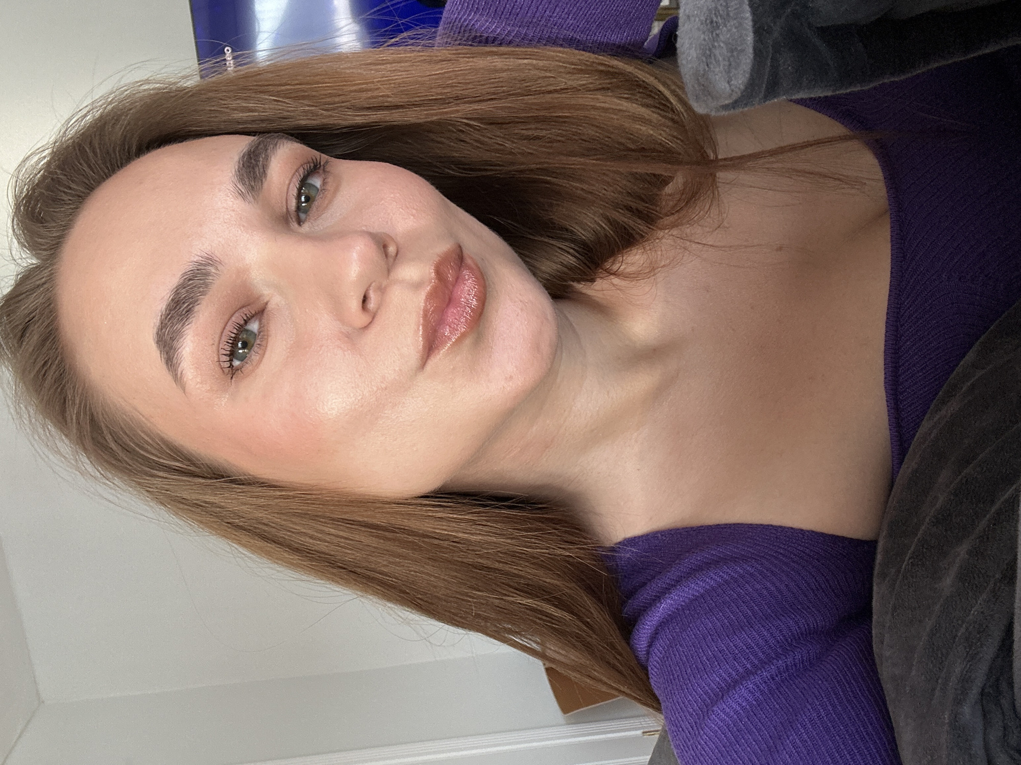 Woman poses for camera in purple top in Russian home
