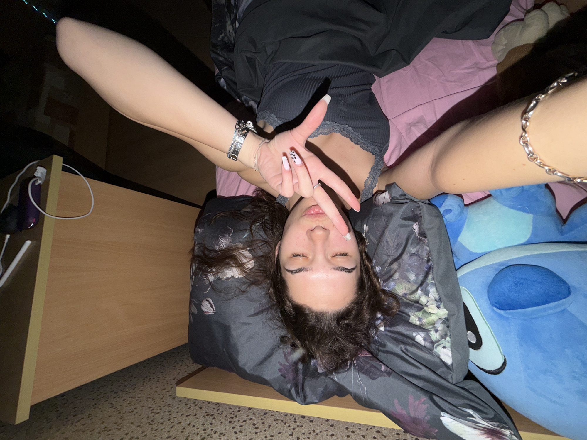 Young woman takes multiple selfies lying down in Sofia