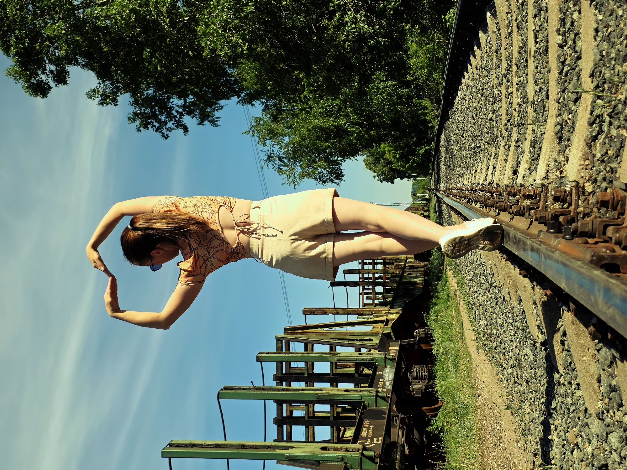 Woman walks on railroad tracks in Chaikovsky, Russia