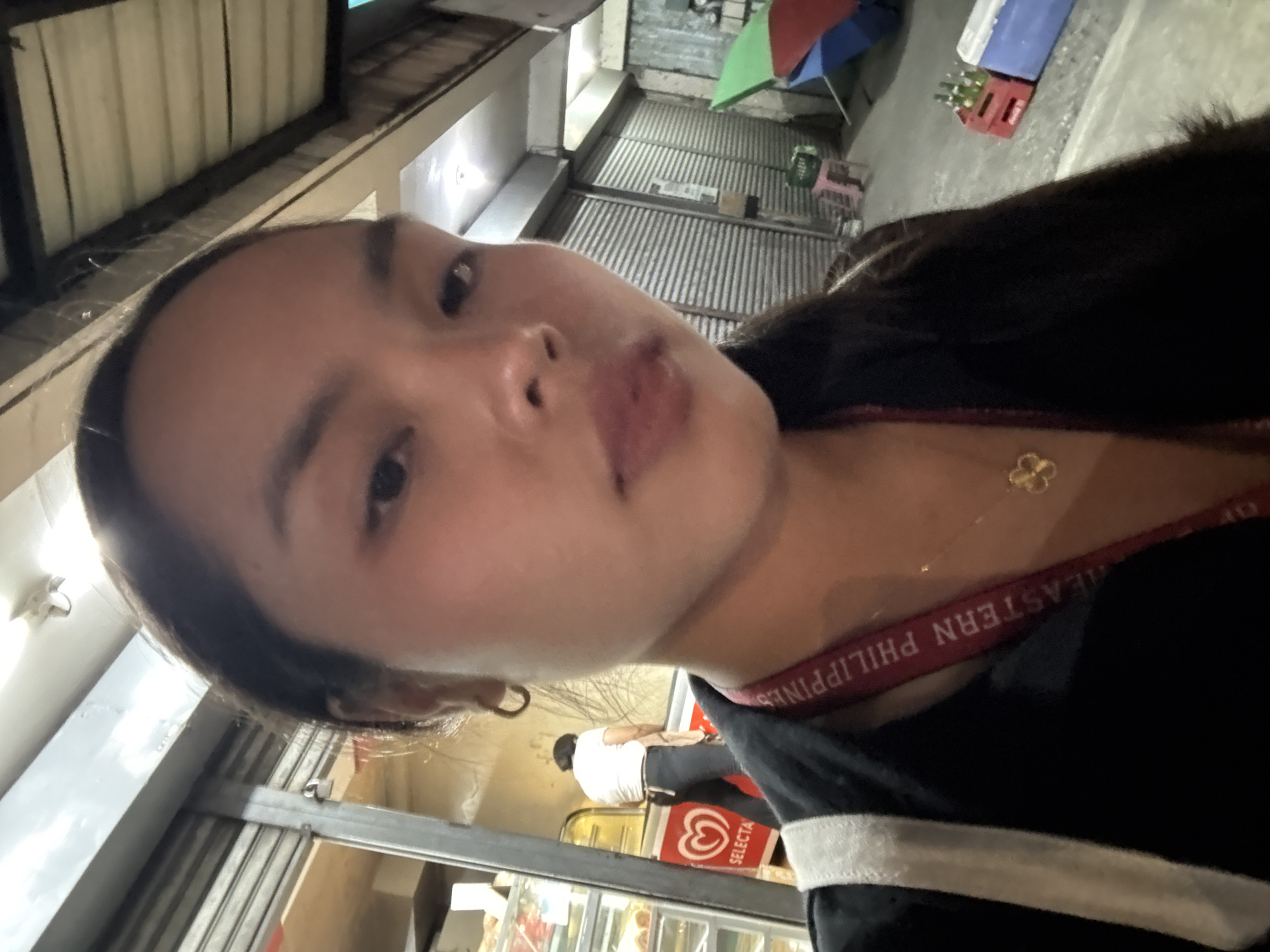 Woman takes selfie wearing Eastern Philippines strap in Davao