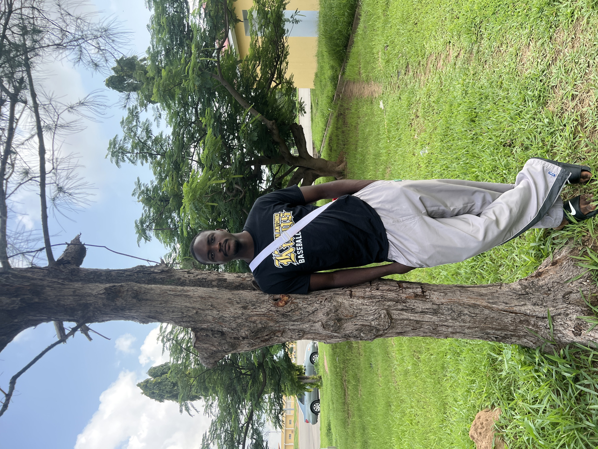 Casual morning street life around a shaded spot in Jalingo