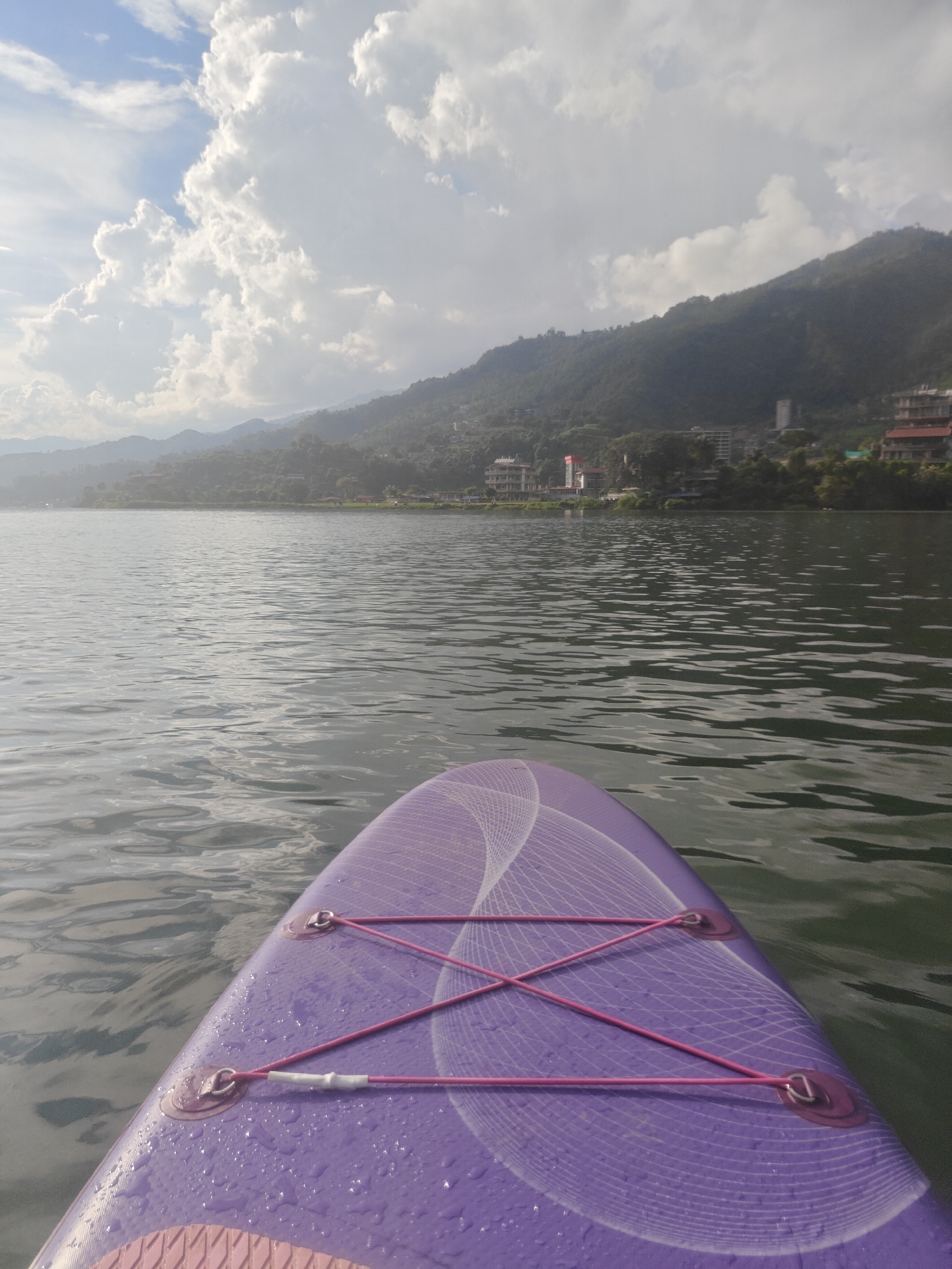 Paddleboarding on Phewa Lake, Pokhara, under a cloudy sky