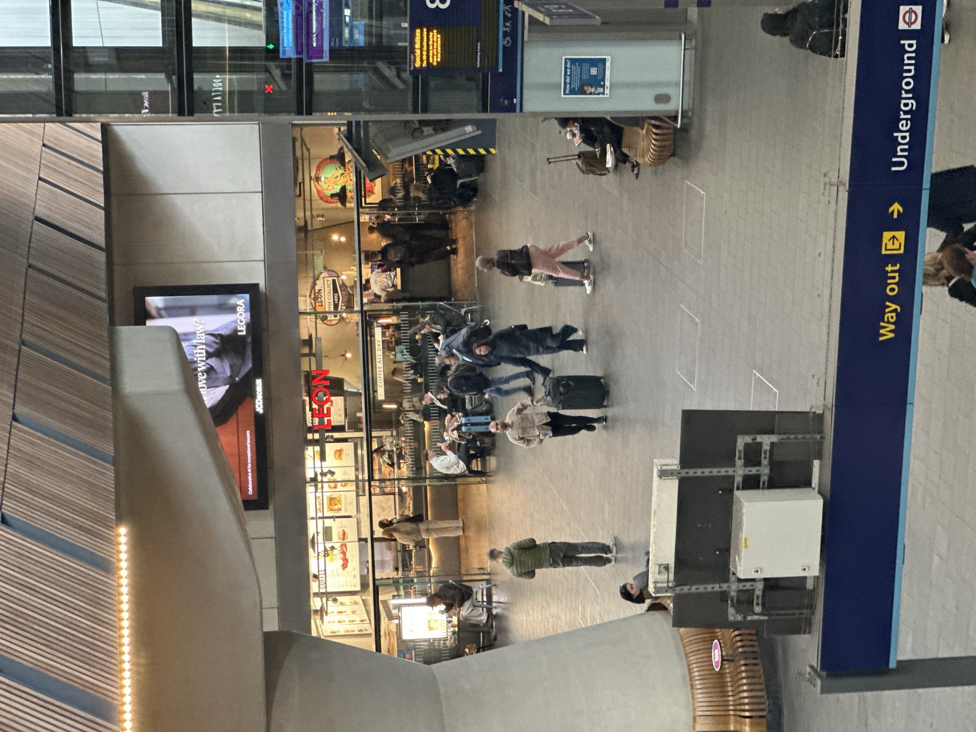 London train station bustling with travelers carrying luggage