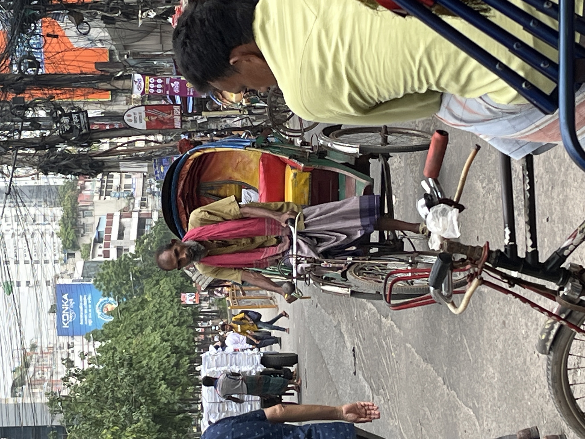 Colorful rickshaws navigate morning streets in Dhaka, Bangladesh