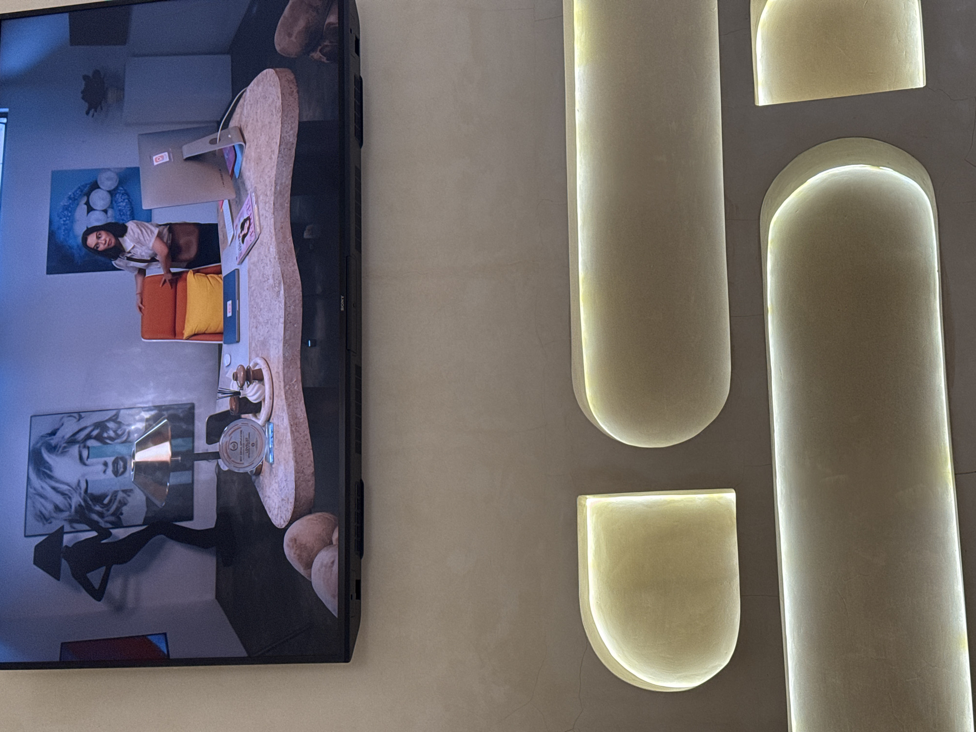 Inside a modern Ubud salon — interiors, a TV screen, and coffee