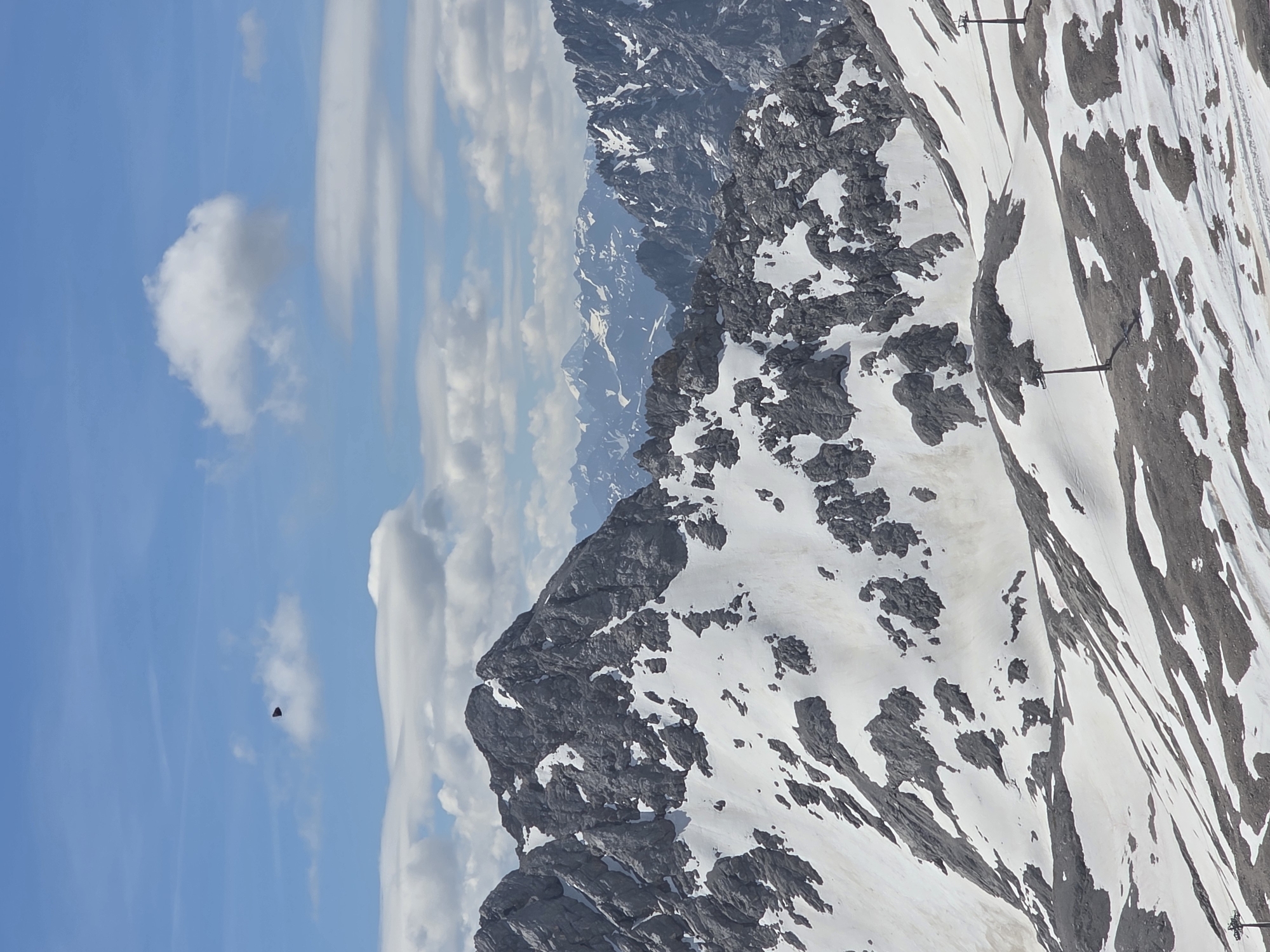 Dark triangular object spotted over snowy mountain landscape