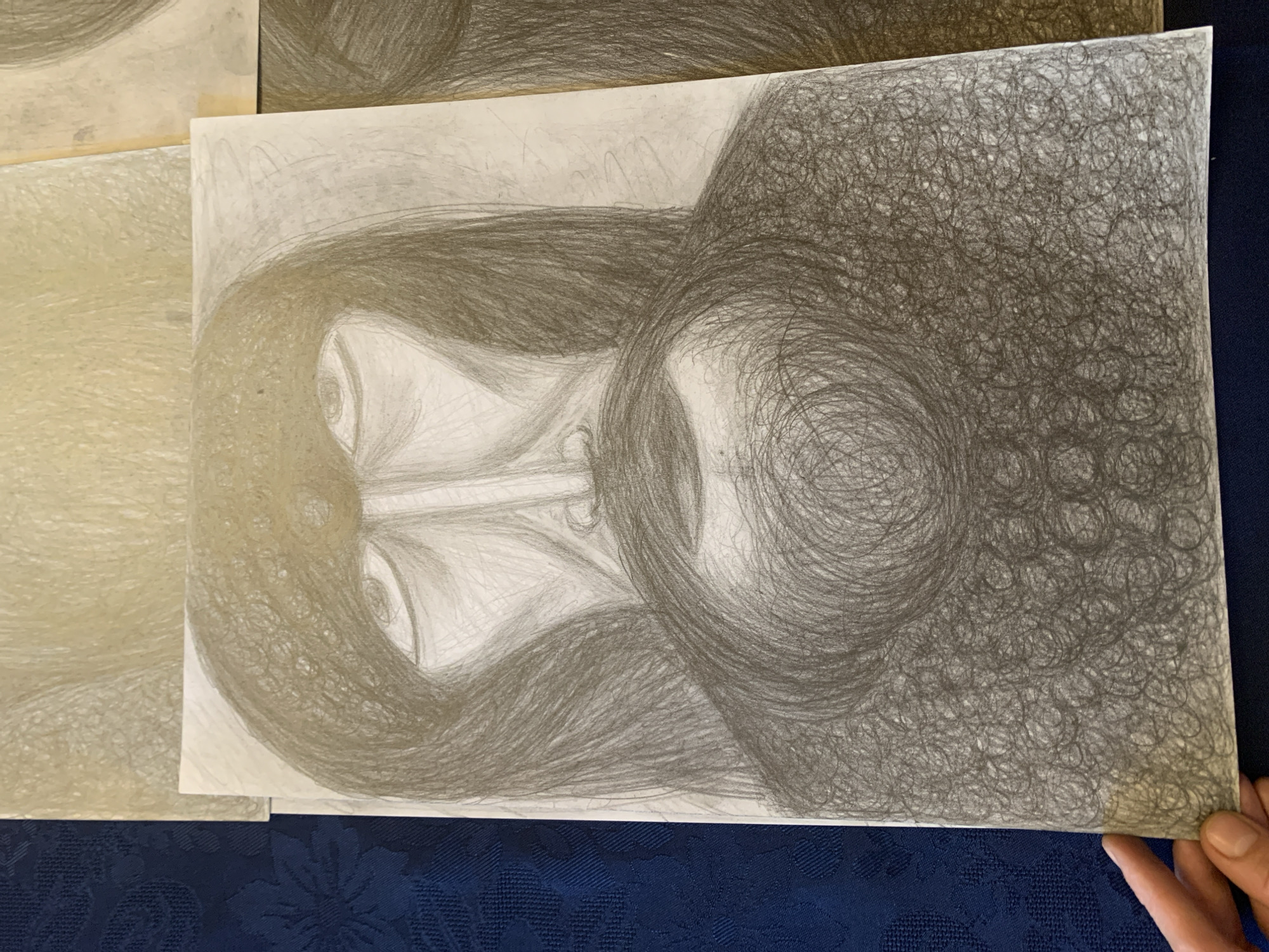 Indoor art collection featuring portrait sketches and Klimt prints