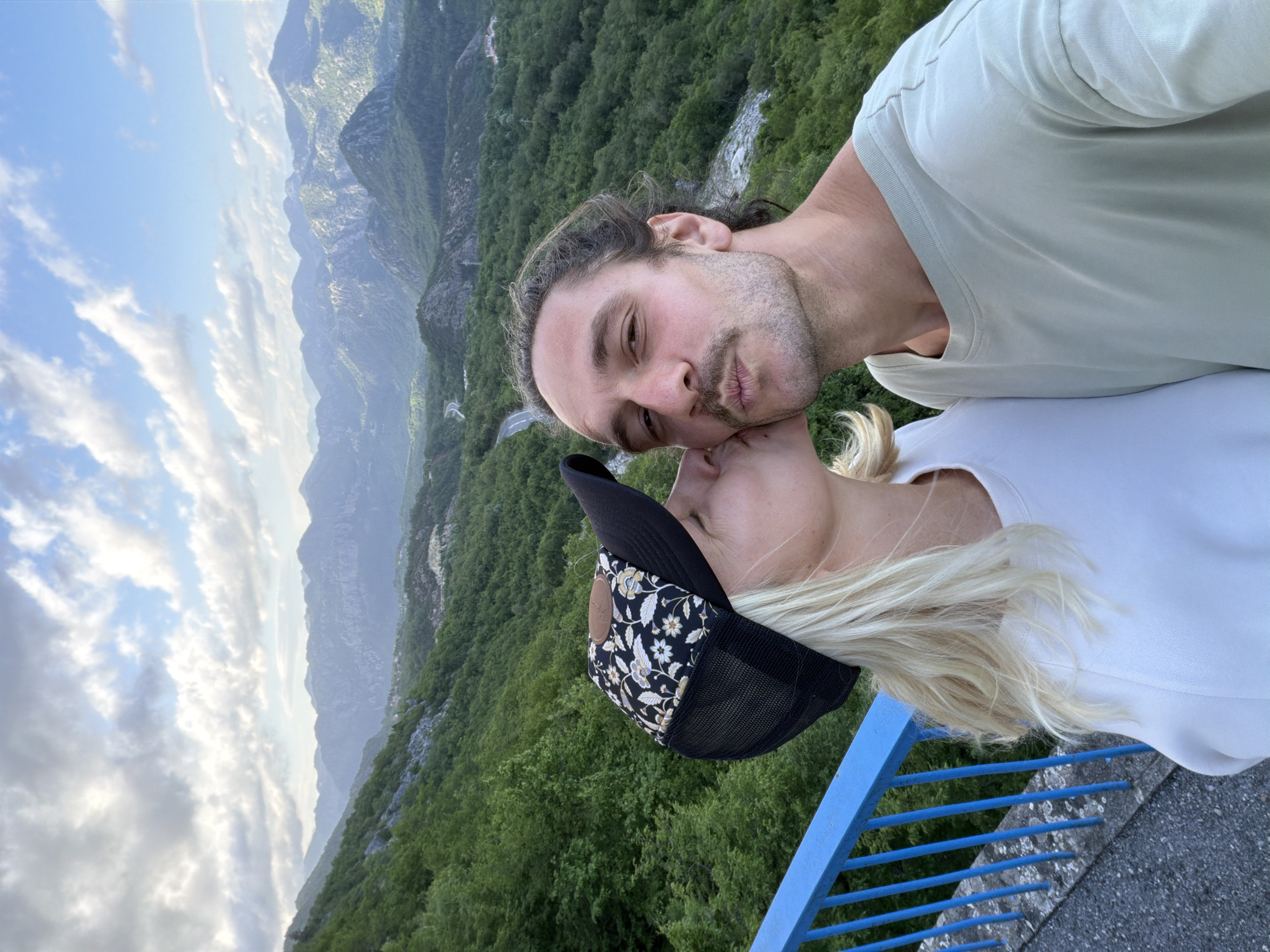Couple photographs scenic moment at Montenegro mountain overlook
