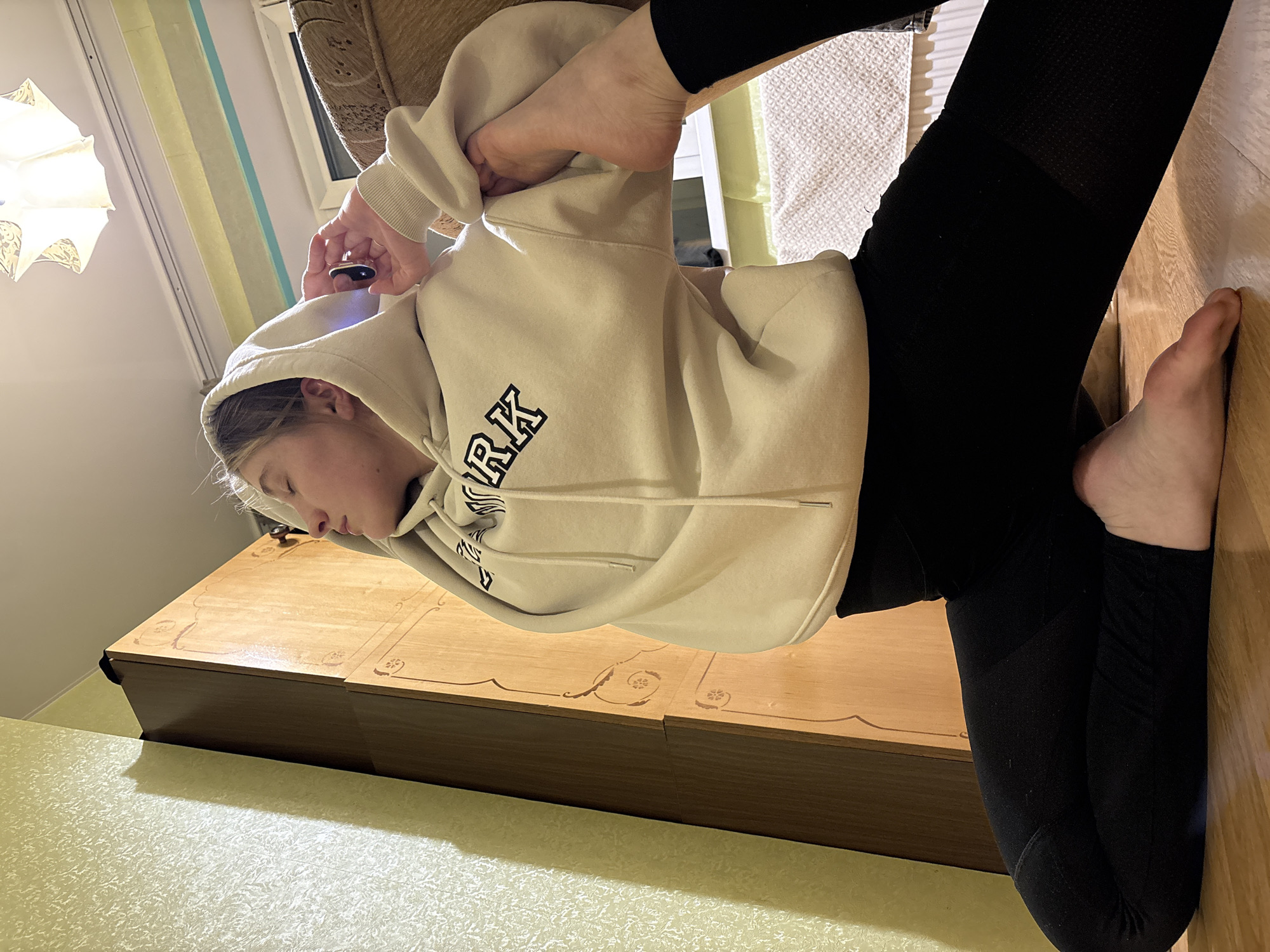 Young woman exercises, poses indoors during afternoon in Izhevsk
