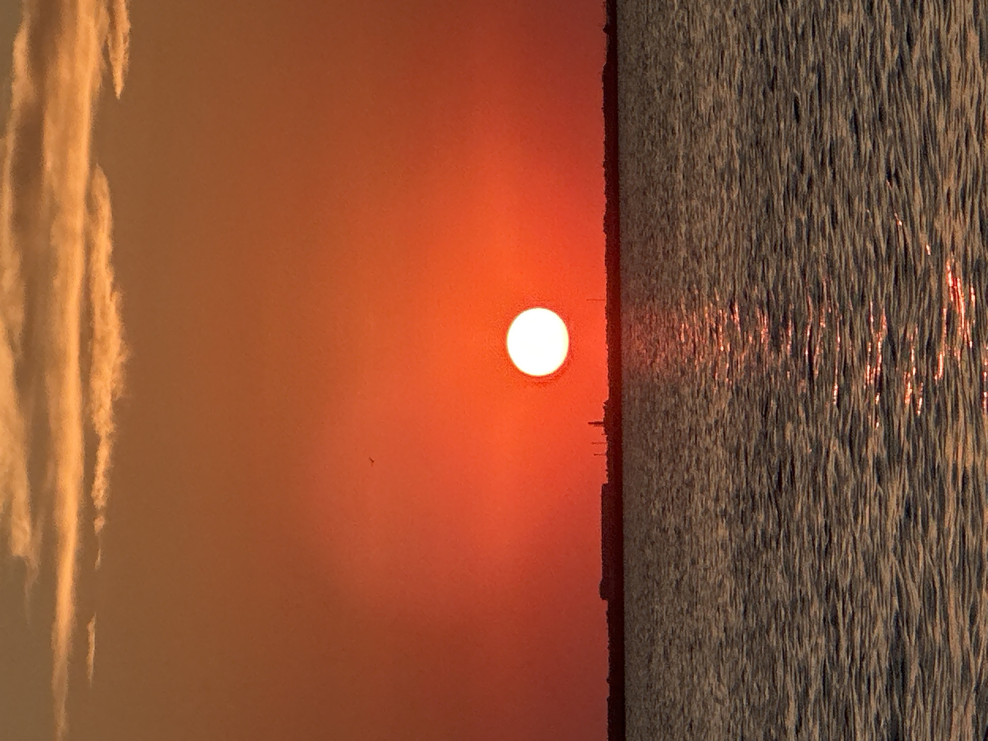 Vivid orange sunset over a Kokshetau lakeside
