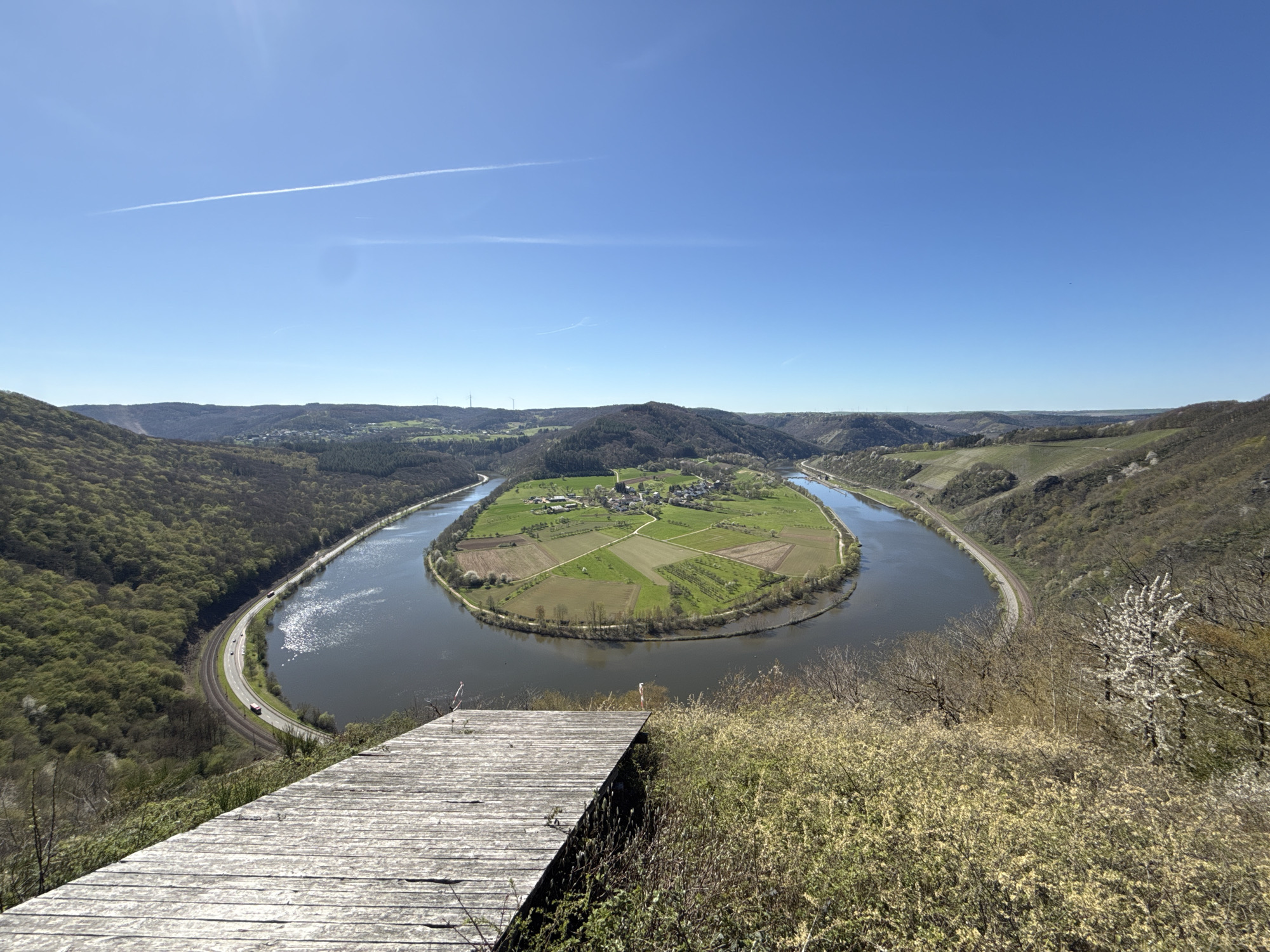 Aerial view captures circular river bend surrounding village island