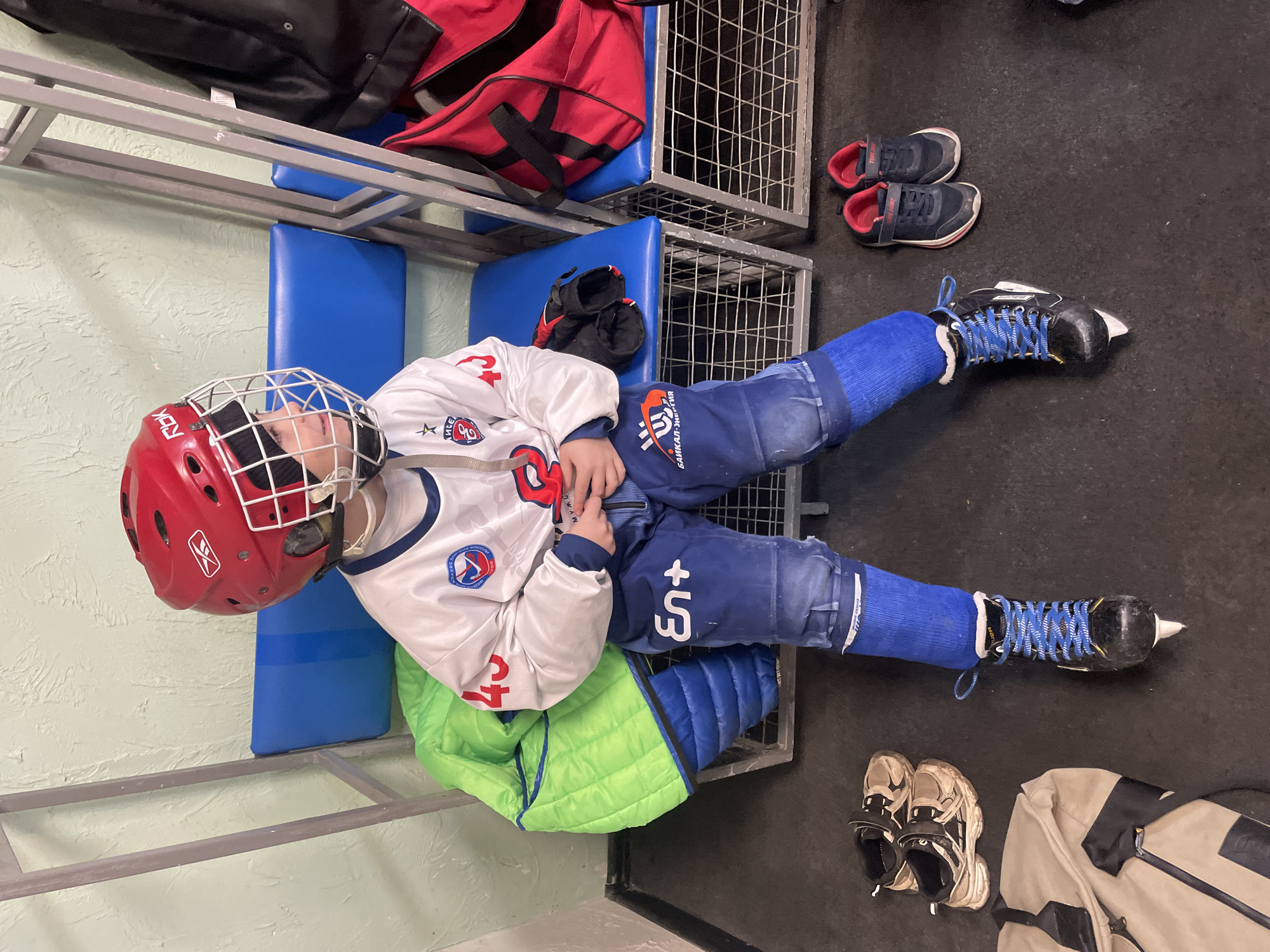 Young hockey player rests in Krasnoyarsk locker room