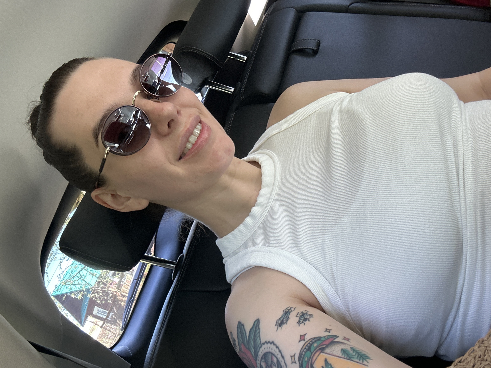 Woman in sunglasses observed in car backseat, Russia
