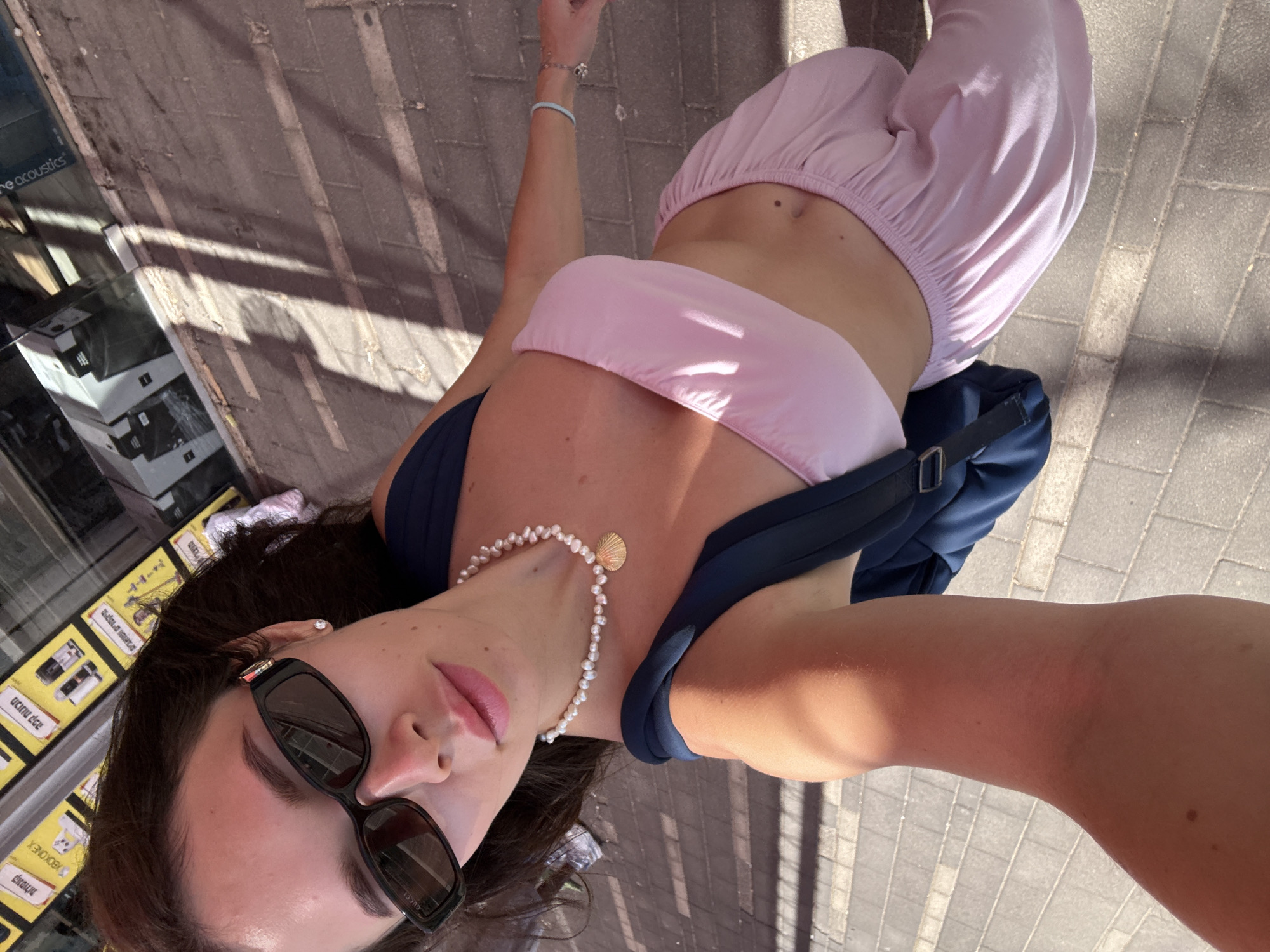 Woman takes selfie outside Eilat store
