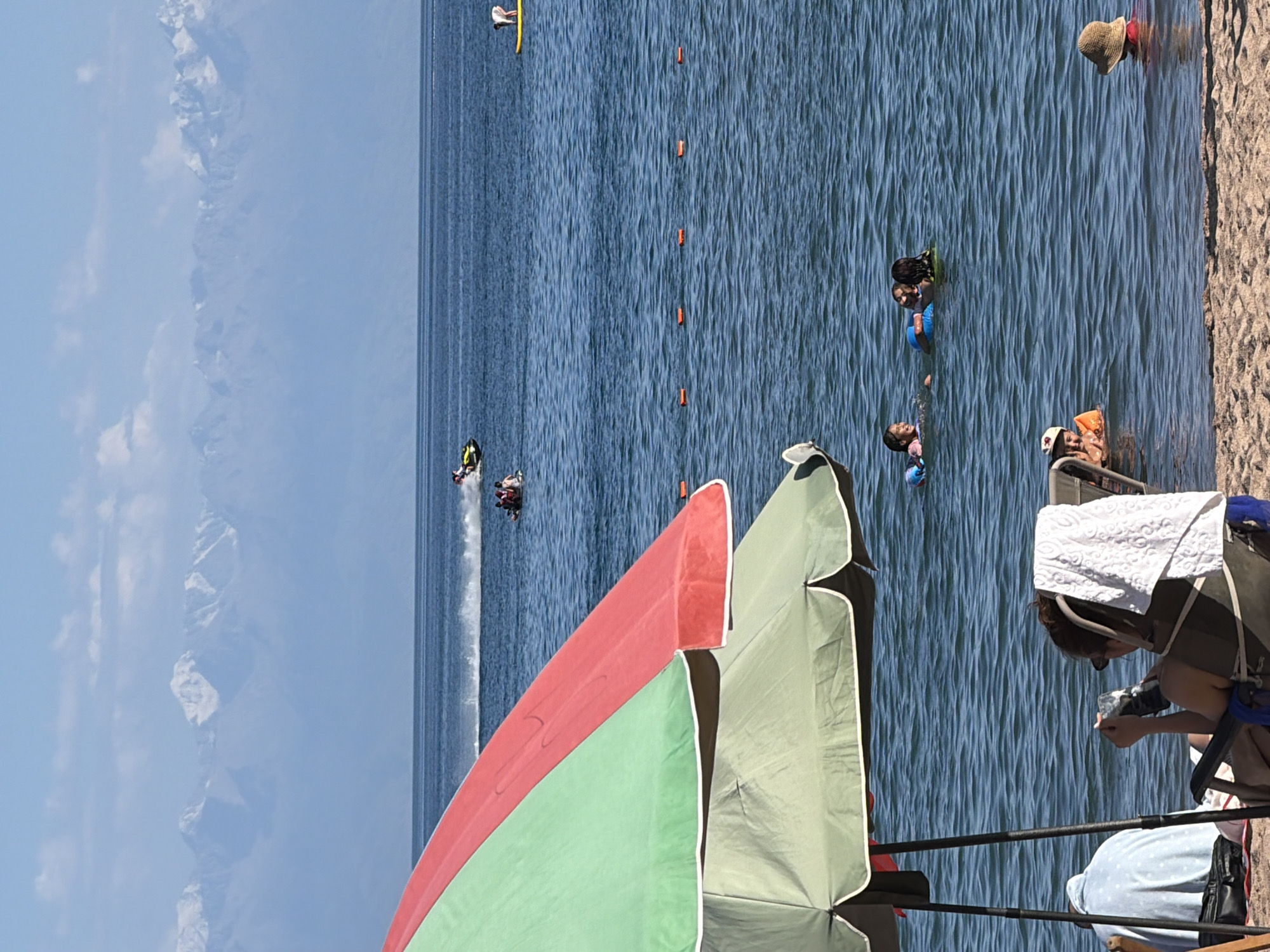 A laid-back beach day, umbrellas out and ocean nearby.