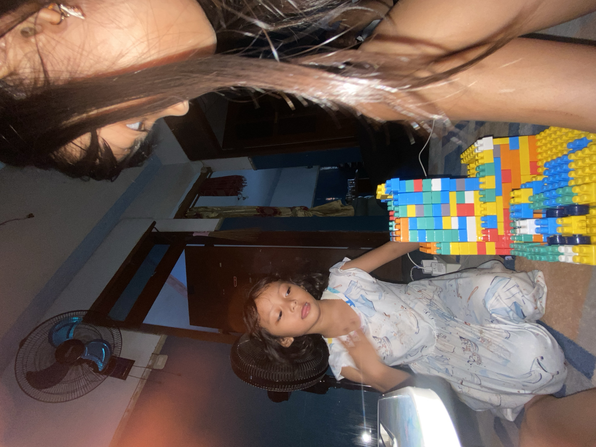 Child and adult play with building blocks in Gelam