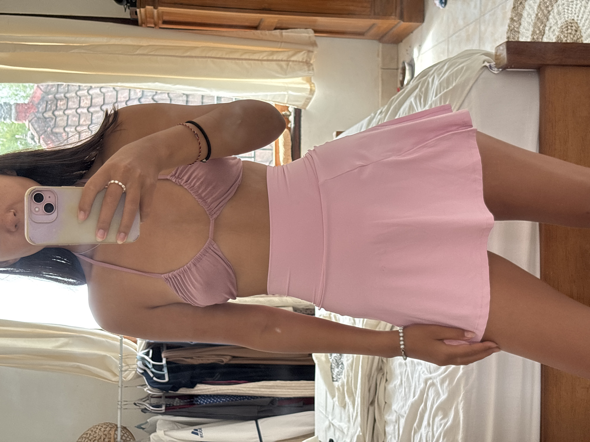 Person takes indoor selfie in pink outfit in Kuta Selatan